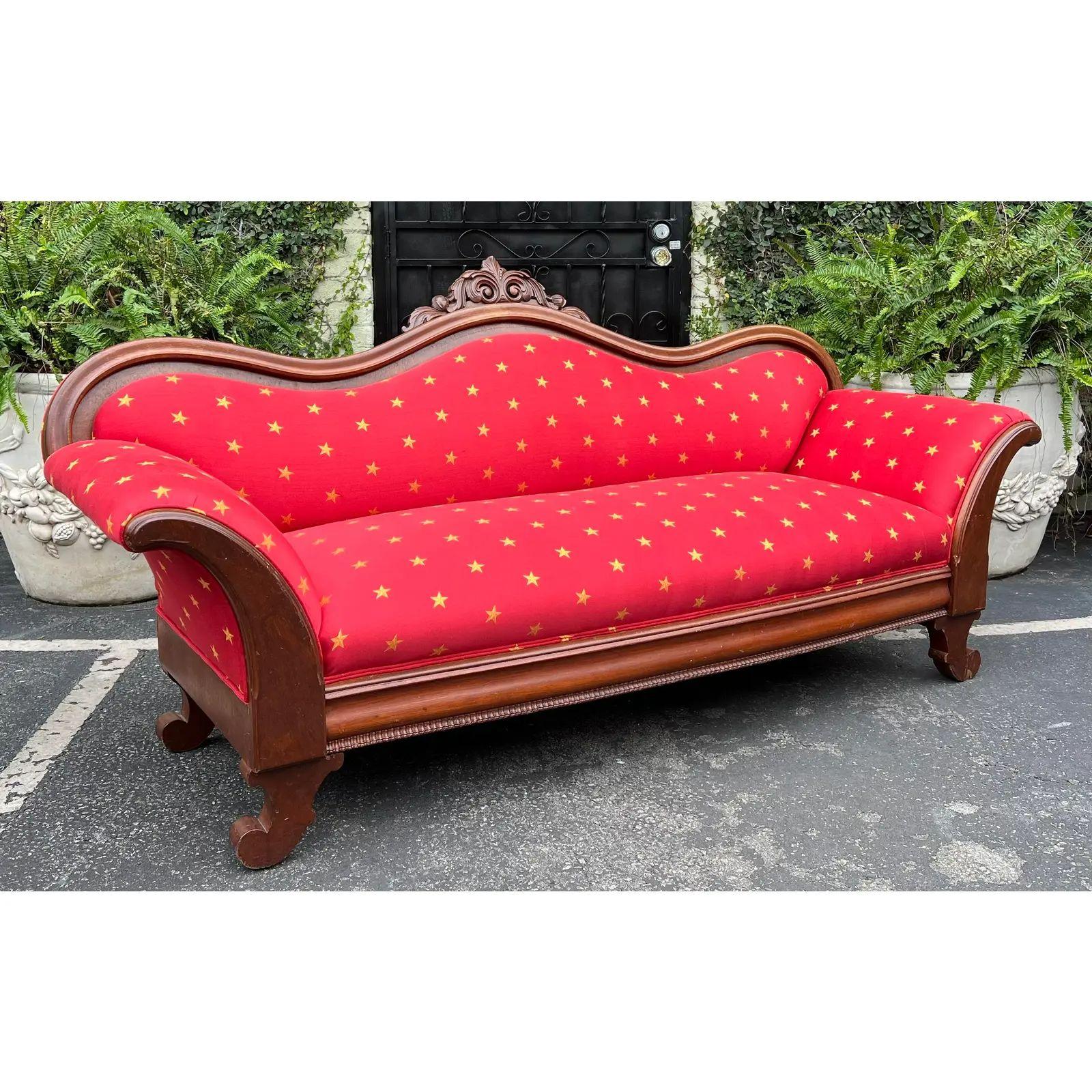 Antique Empire Sofa With Red & Gold Clarence House Fabric. It features an Empire form in solid mahogany and was freshly upholstered in gold star on red Clarence House fabric. 

Additional information: 
Materials: Fabric, Mahogany
Please note