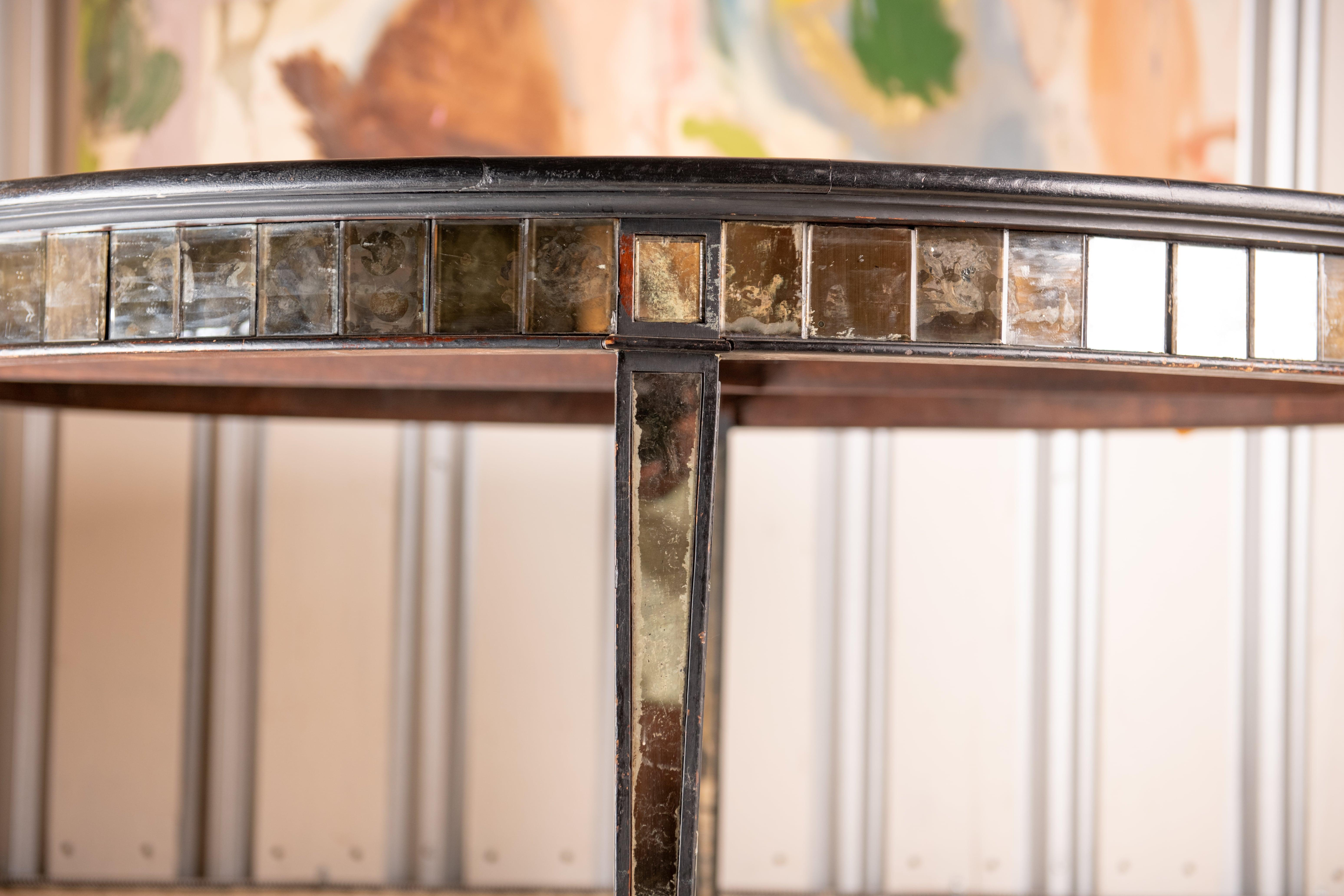 This beautiful Antique Empire style table is one of a kind and a stunner.  Antique mirror and Black lacquer wood trim. it would make a gorgeous entry table or dining table and so much more.  the patina of the mirror is  original and truly amazing. 