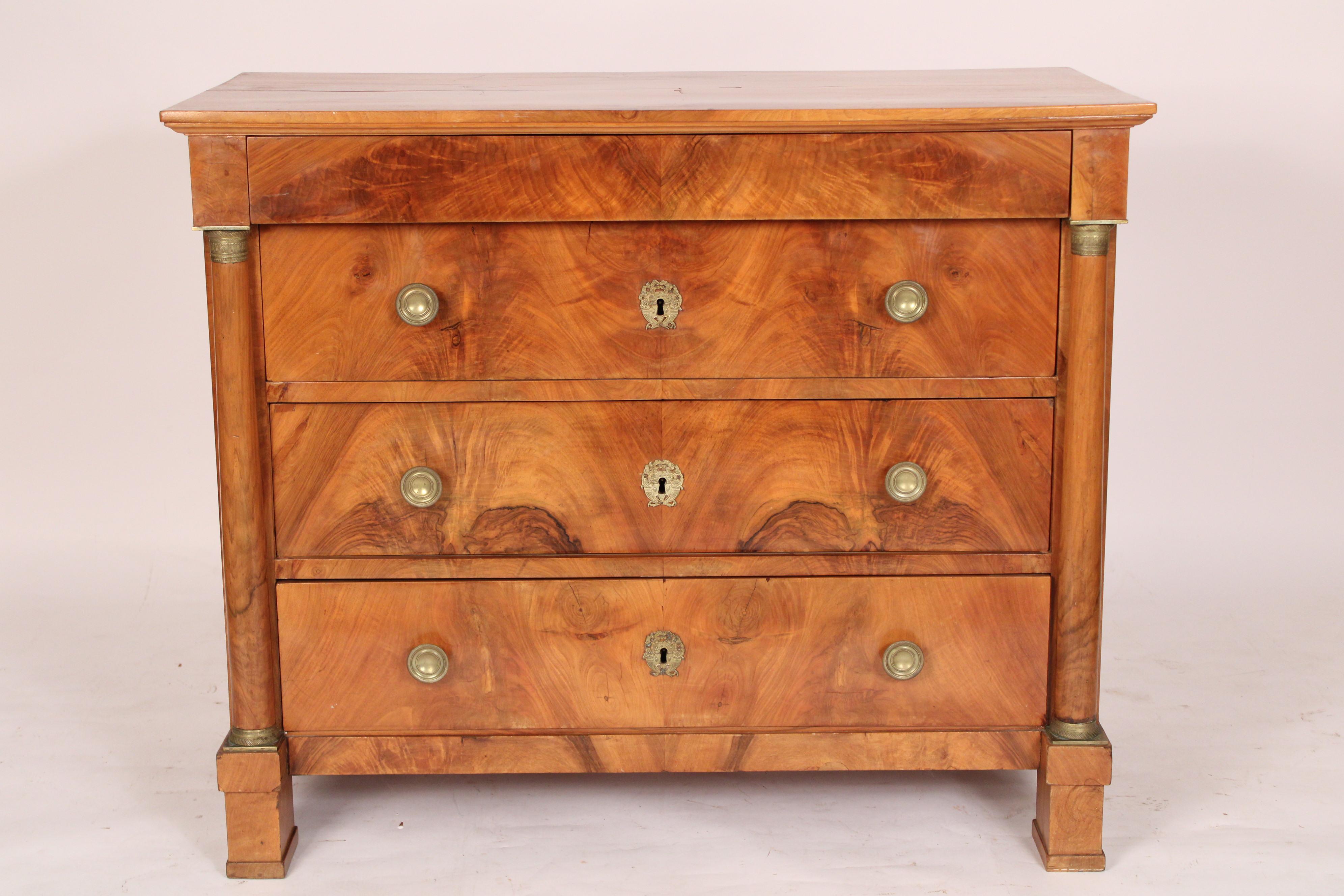 Antique Empire style burl walnut chest of drawers, late 19th century. With an overhanging burl walnut two board top,  an overhanging frieze drawer and 3 burl walnut drawers with bronze knobs and bronze escutcheons,  drawers flanked by columns with