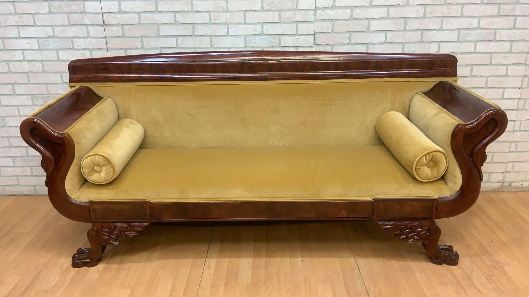 Antique Empire Style Mahogany Swan Grecian Sofa in Yellow

Antique Classic Empire style carved mahogany Grecian sofa upholstered in yellow gold velvet. The sofa has carved swans head arm rest, carved corner cornucopia and standing on ebonized