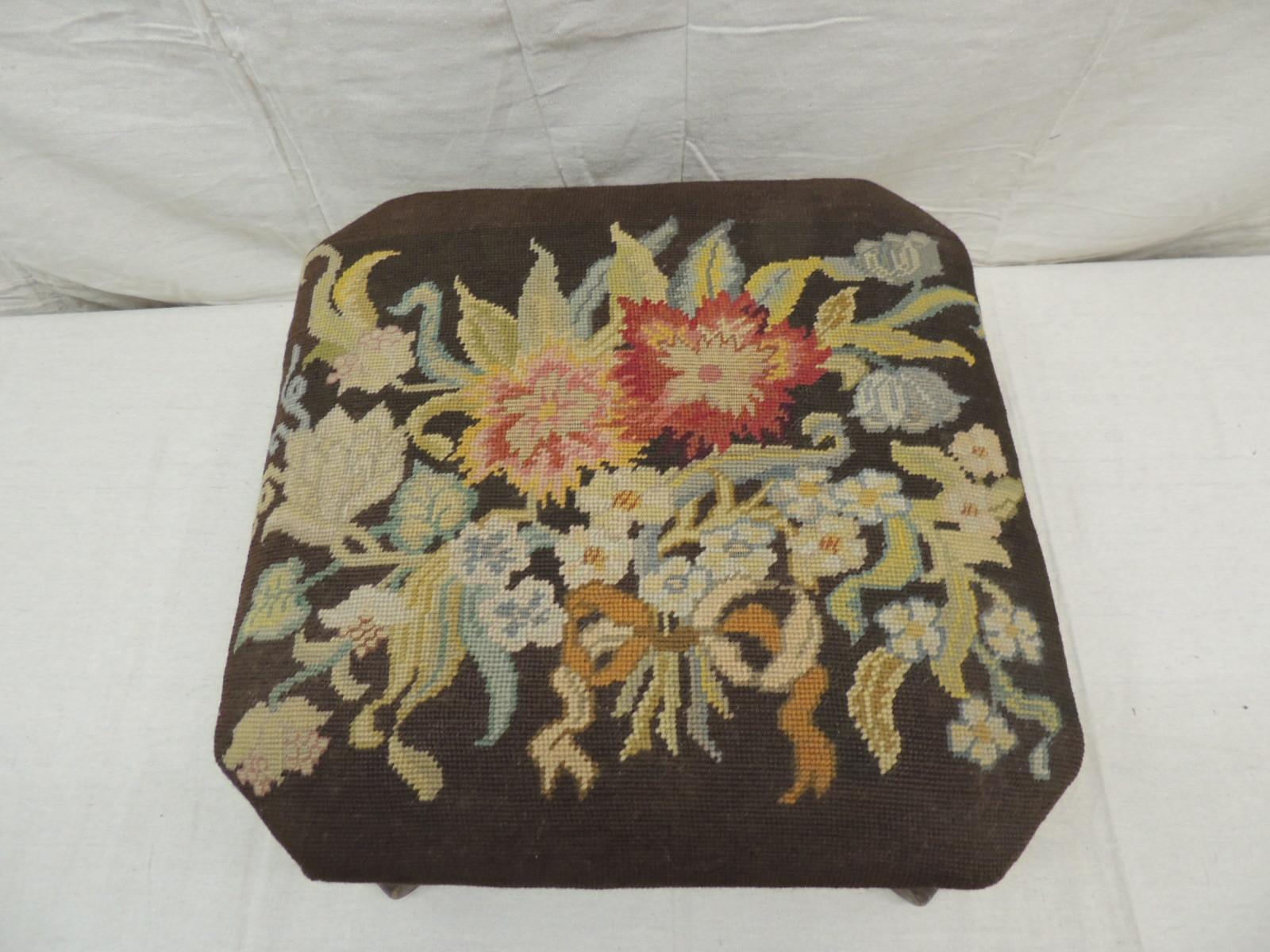 Antique Empire style tapestry footstool
Wood ottoman with turned wood legs, tak details all around covered with a bouquet of flowers tapestry.
In shades of green, yellow, pink, red, blue and brown
Size: 17.5” x 17.5” x 10” H.
 