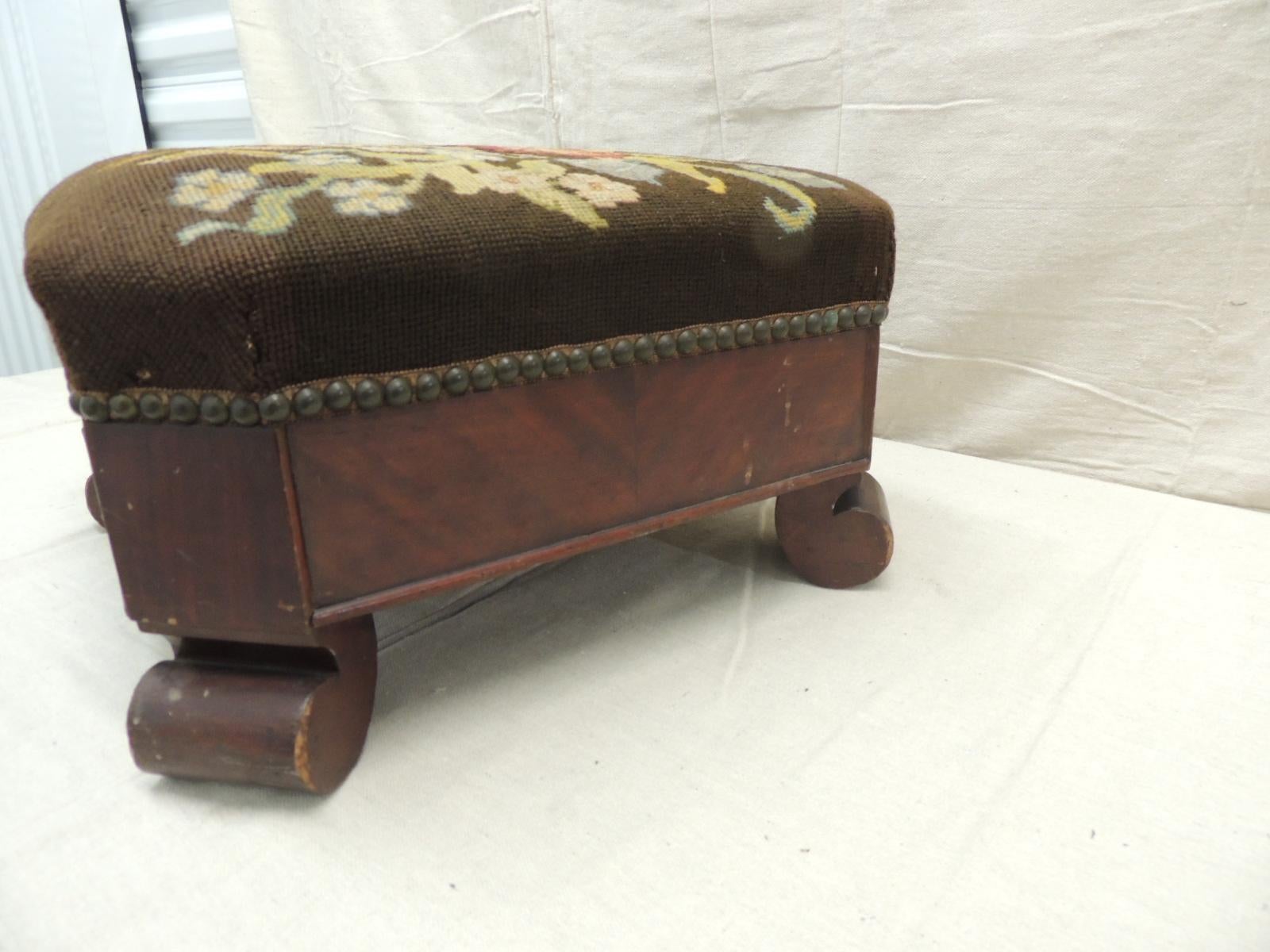 cushioned footstool associated with empire