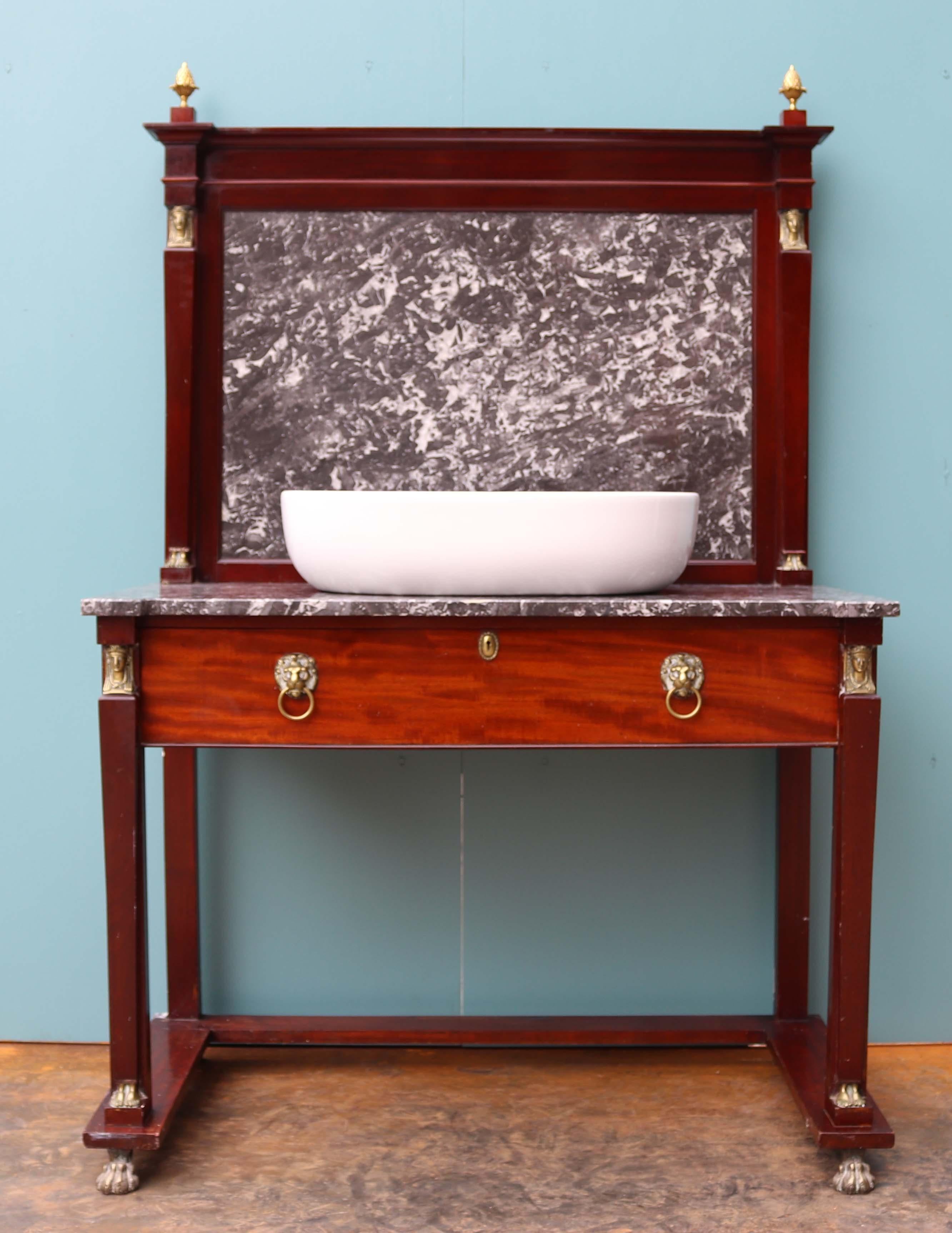 About

This beautiful washstand is made from mahogany and a grey/white marble with brass embellishments in the Egyptian taste. The basin is made from porcelain but has not been fitted . 

We have paired this original wash stand with a modern