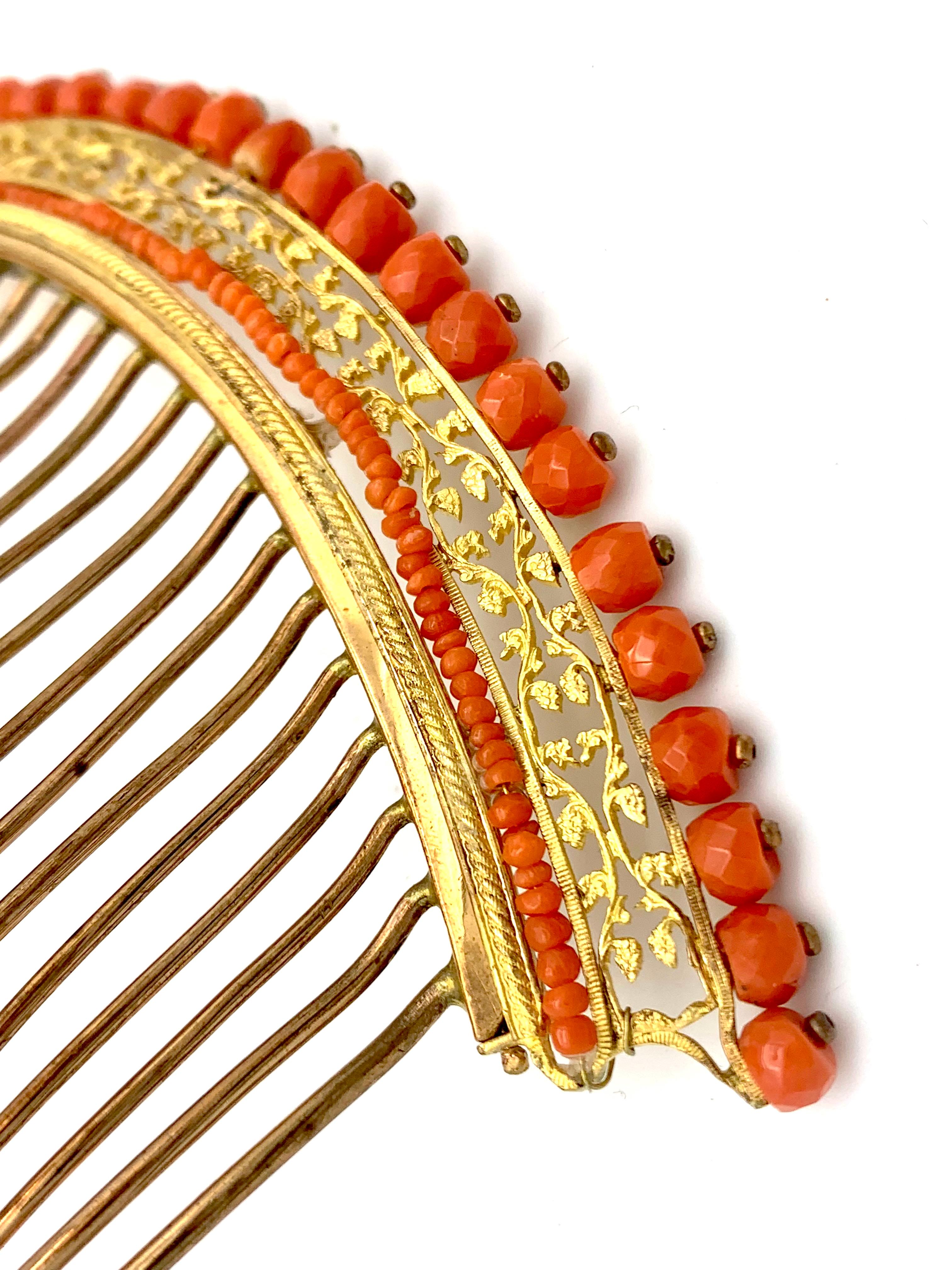 Dieses Empire-Diadem wurde um 1810 aus feuervergoldetem Metall hergestellt. Es ist mit fünfunddreißig facettierten Corallium-Rubrum-Perlen verziert, die auf das Kopfornament genietet sind. Das Diadem ist mit einer durchbrochenen Bordüre versehen,
