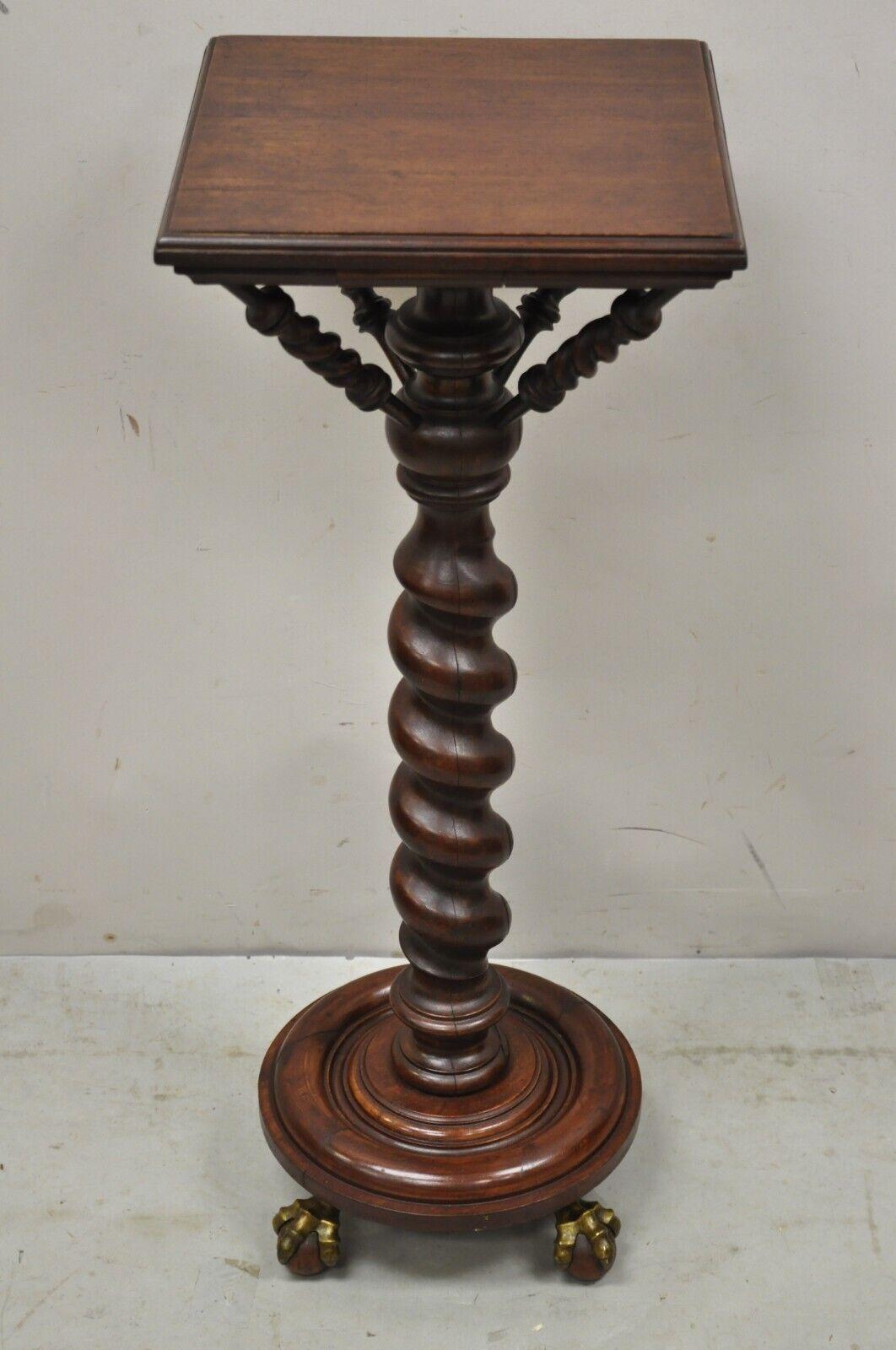 Antique Empire Victorian walnut barley twist spiral carved pedestal stand. Item features brass claw feet with wooden spheres, spiral barley twist shaft, square top, turn carved supports, beautiful wood grain, very nice antique item, great style and