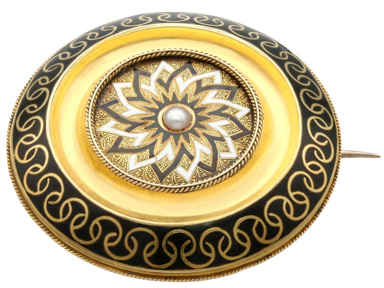 An impressive Victorian seed pearl and enamel, 15 karat yellow gold mourning brooch; part of our diverse antique jewelry collections.

This fine and impressive antique brooch has been crafted in 15k yellow gold.

The brooch has a domed circular