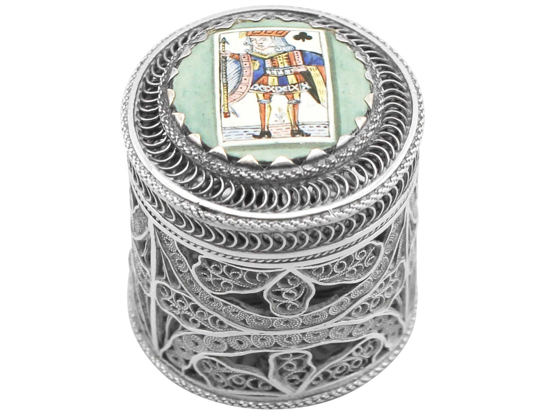 An exceptional, fine and impressive antique enamel and English silver filigree box; an addition to our silver ornamental collection.

This exceptional antique English silver counter filigree box has a cylindrical form.

The surface of this