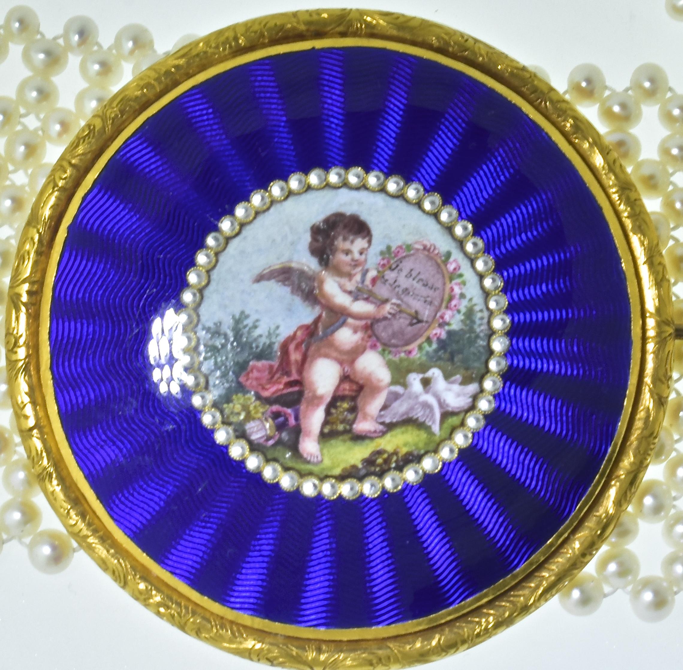 Antique brooch displaying a wonderful array of enameling.  It is shown on a woven pearl contemporary dog collar which has a gold clasp.   It can be worn both as the center to this collar or removed and worn separately.  The woven pearl collar is