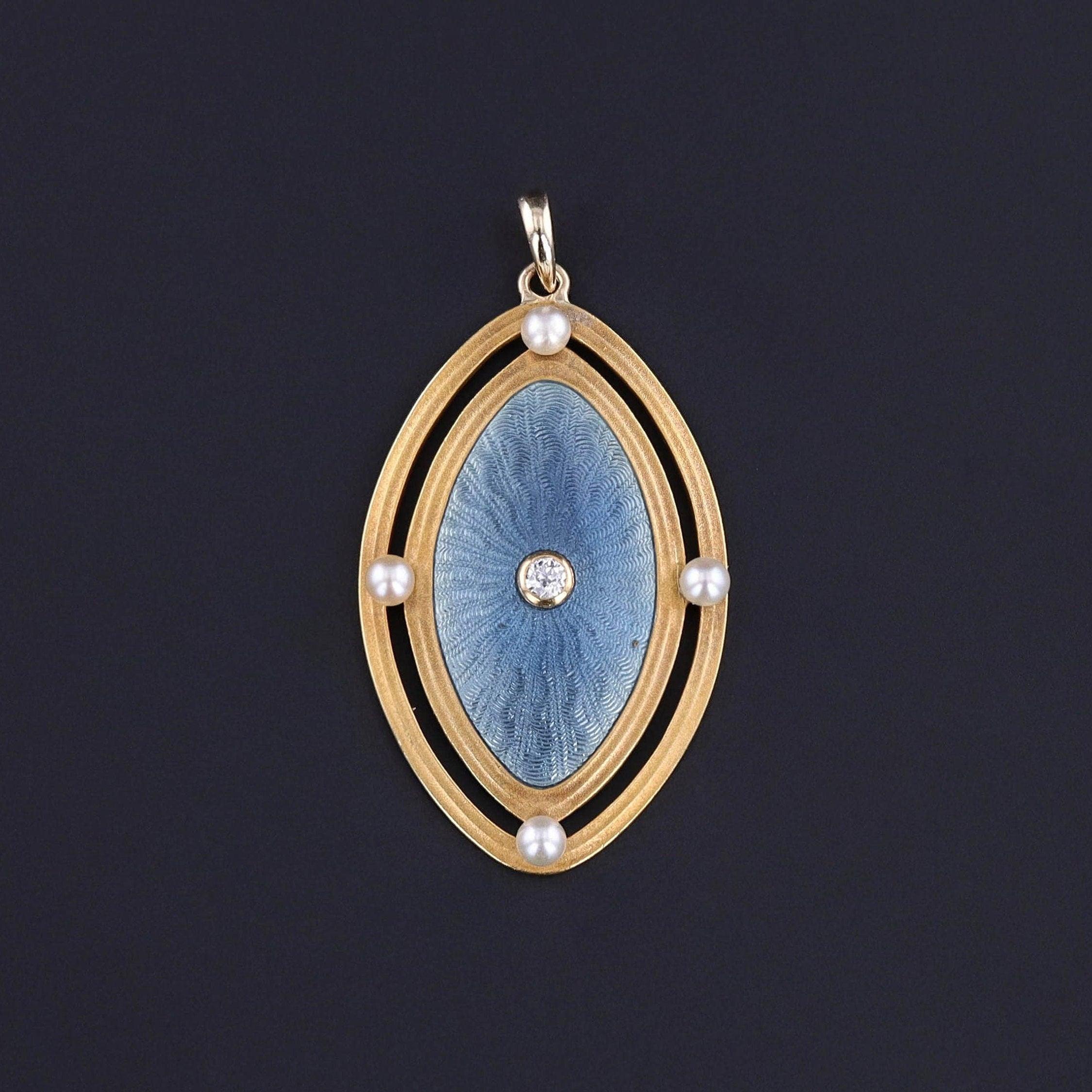 Prova un'eleganza senza tempo con il nostro ciondolo in smalto arabescato blu, impreziosito da un diamante centrale e da quattro perle incastonate. Originariamente una spilla in oro 14k del 1900, è stata trasformata dal nostro gioielliere in un