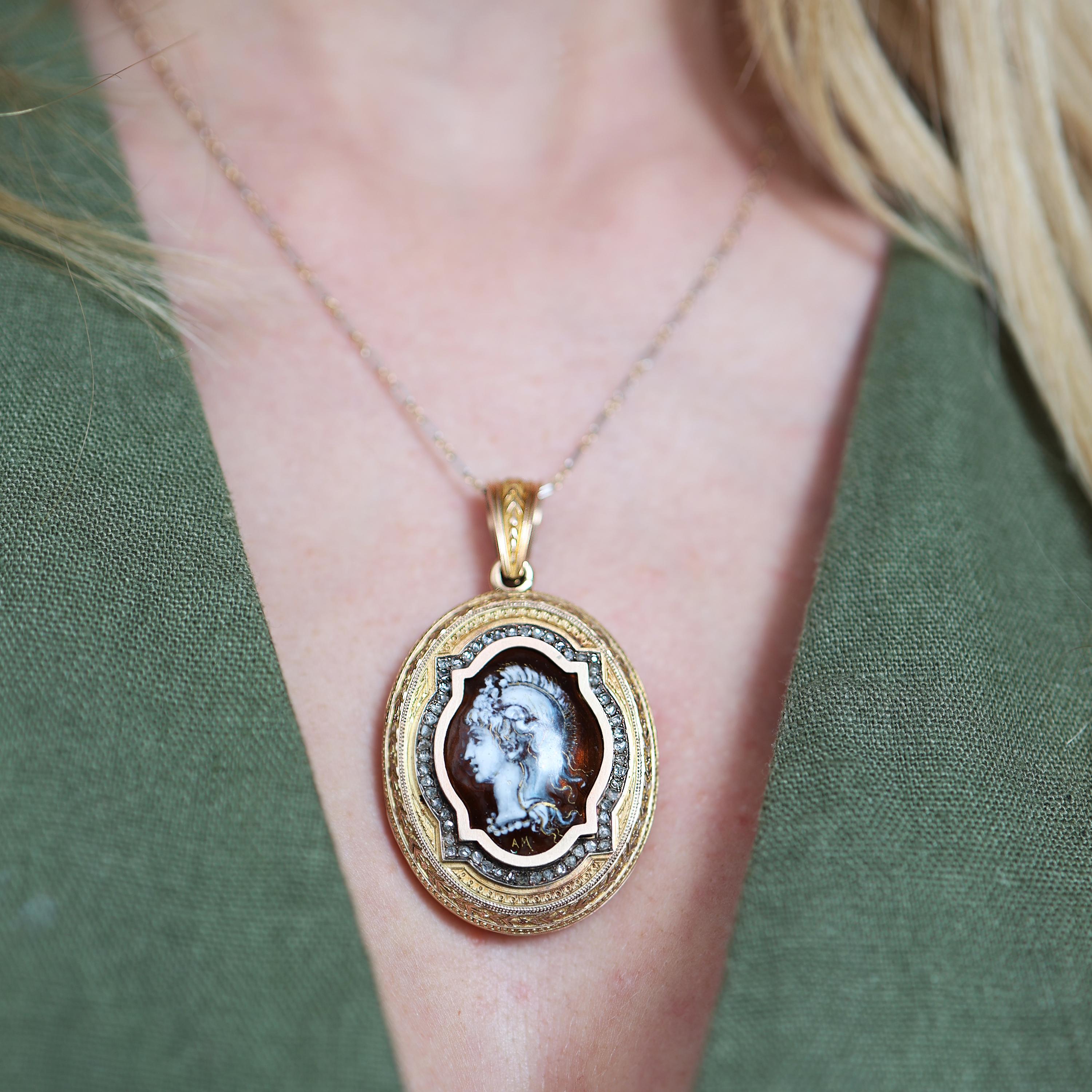 An antique enamel, diamond and gold locket pendant, with a domed enamel centre plaque, depicting the goddess Minerva, in monochrome white and grey highlighted with gold, on a brown background, signed AM, in an oval and rectangle frame, surrounded by