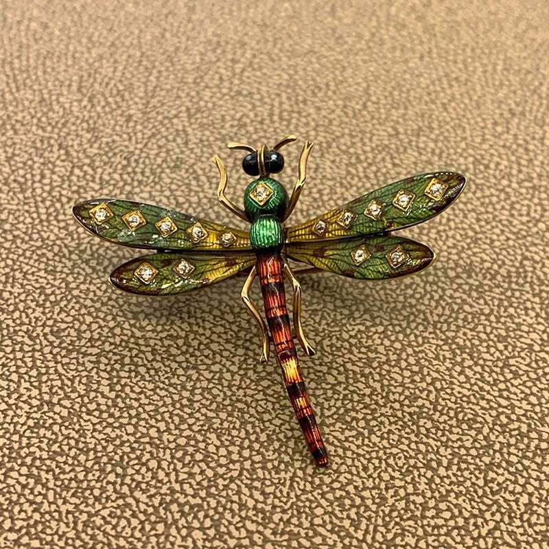 A diamond studded hand-painted enamel dragonfly from the 19th century. Made in 14K gold this piece will complement and bring life to any outfit.