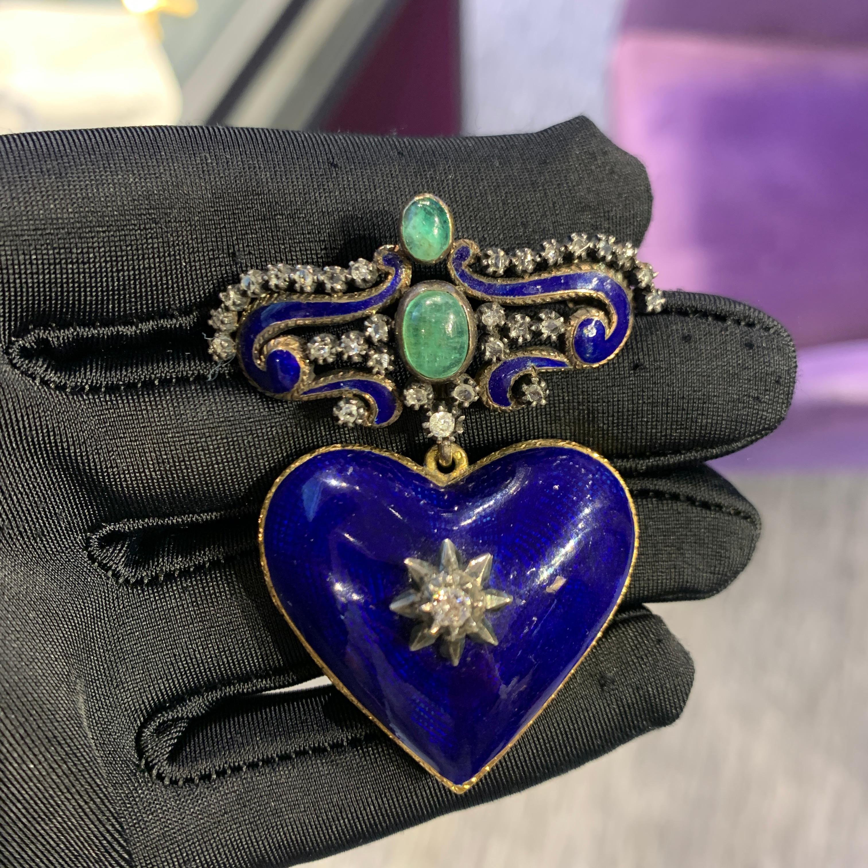 Diamond & Emerald Heart Shaped Blue Enamel Locket Brooch

An 18 karat and 14 karat gold brooch featuring a heart shaped locket. The brooch is set with 2 cabochon emeralds, 30 round cut diamonds, and blue enamel. 

Measurements: 2.38