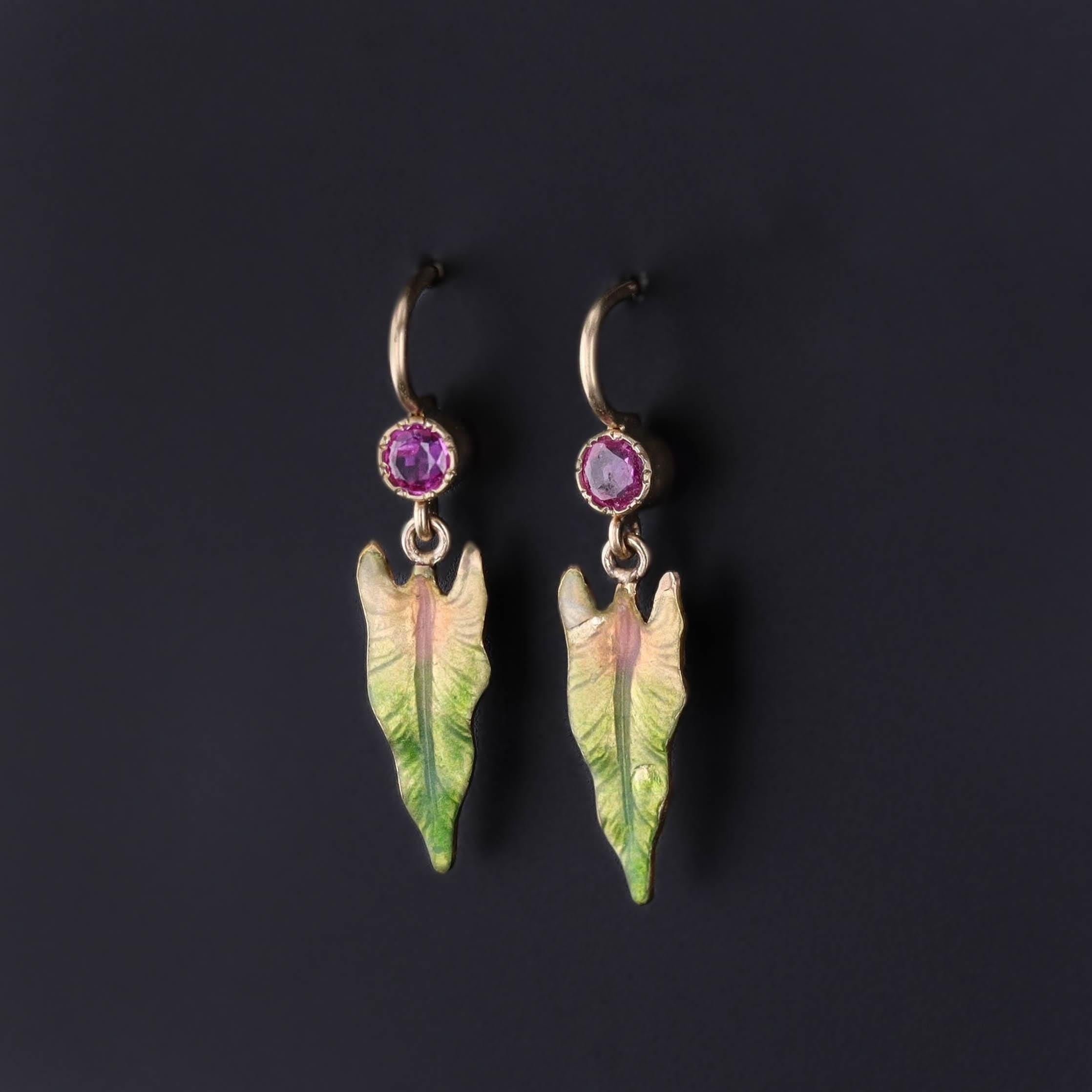 Antique Enamel Leaf Earrings: These earrings feature leaves of 14k gold, adorned with lustrous enamel. They were created from an antique pin (circa 1910) by adding 14k gold ear wires and ruby surmounts.

Each earring measures 1 inch from the top of