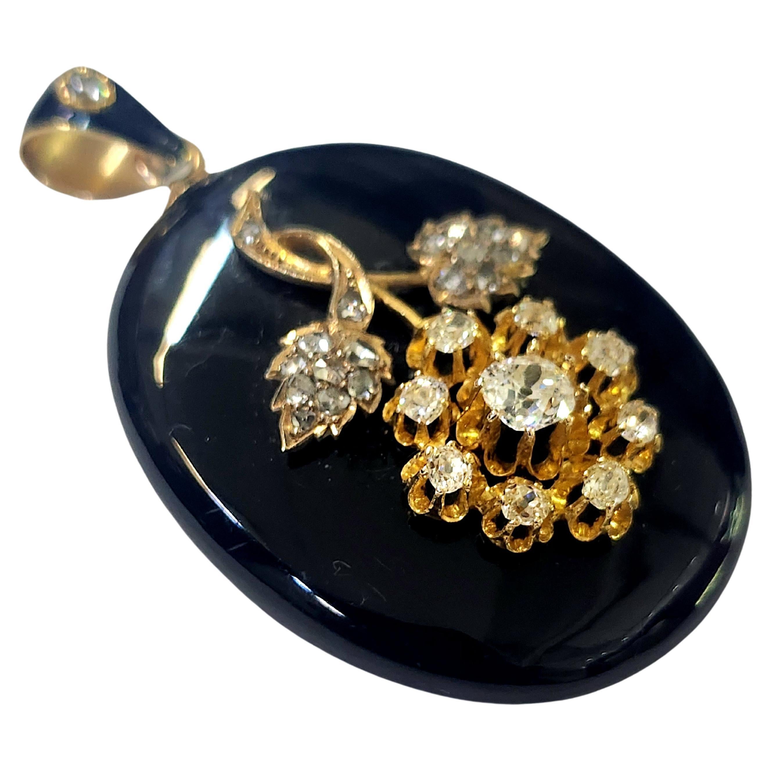 Rare antique large 14k gold pendant with black enamel in excellent condition topped with 14k gold floral centeted with old mine cut diamond estimate 1 carat flanked with old mine diamonds H color white excellent spark 