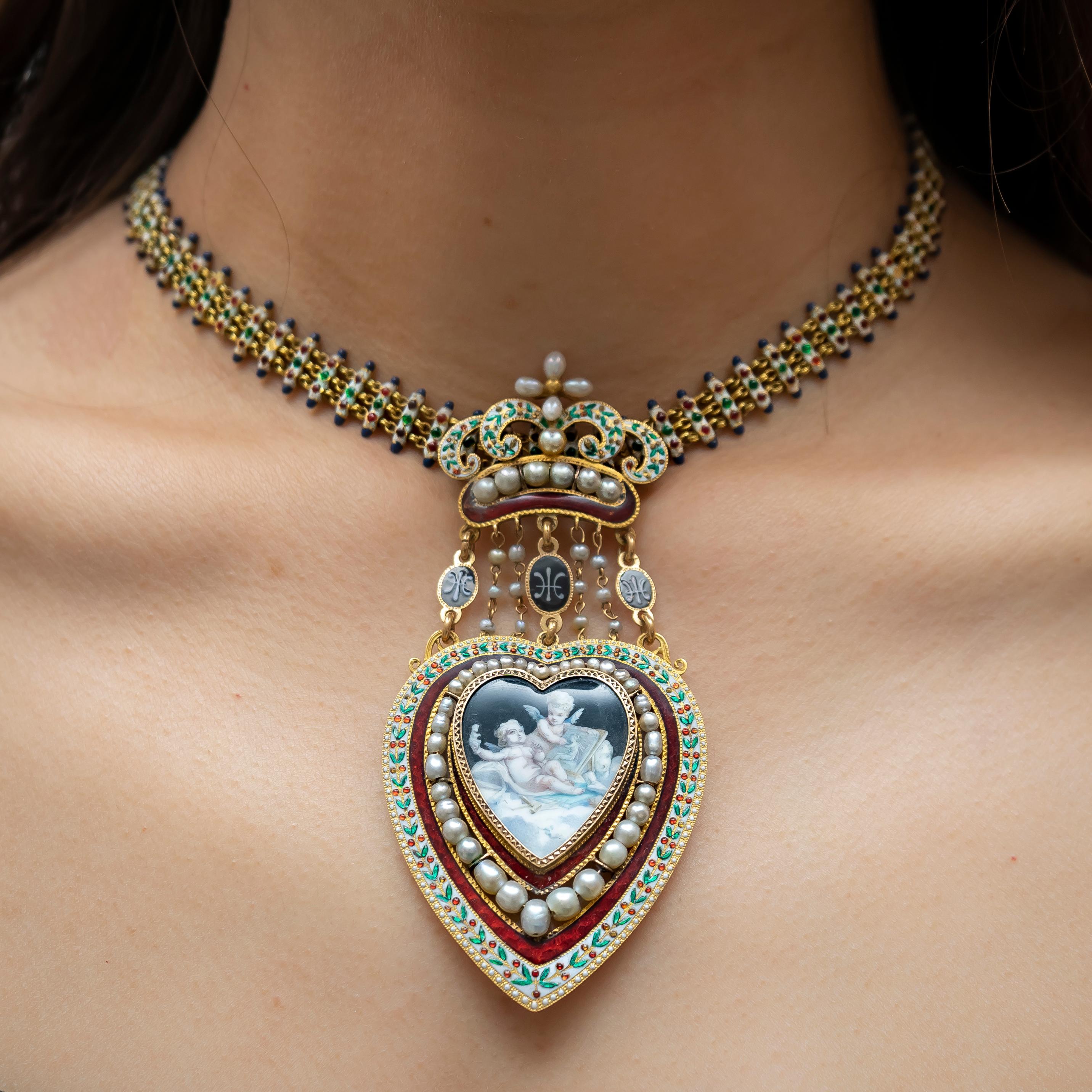 An antique enamel and pearl necklace, central painted enamel heart depicting two cherubs, surrounded by red enamel, a further surround of graduated pearls, red enamel and an outer edge of red, green and white enamel, with a locket back, suspended by