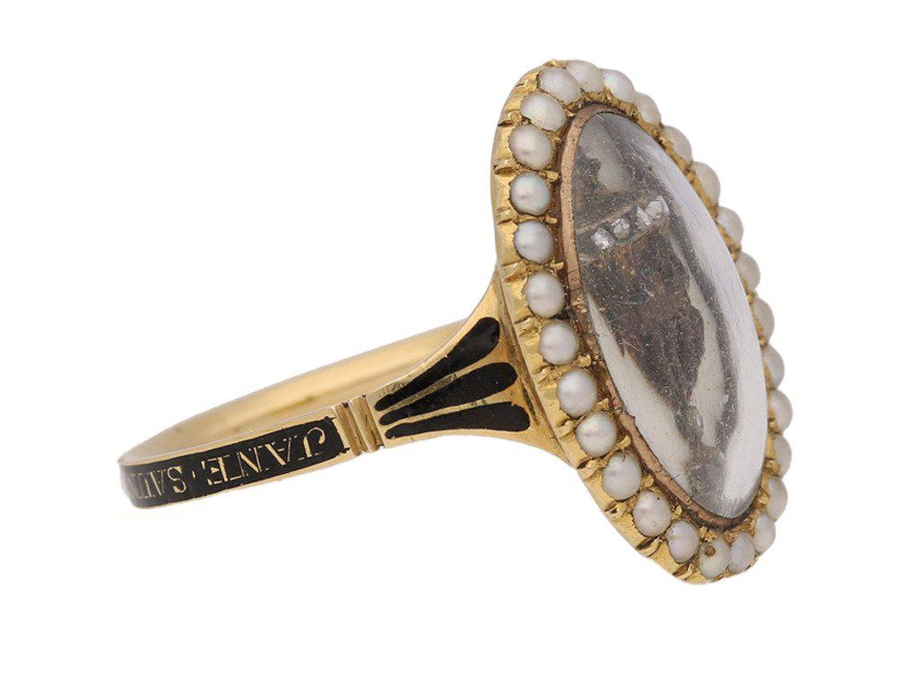 Antique diamond and pearl 'urn' memorial ring. Set with ten round rose cut diamonds in silver cutdown settings with an approximate combined weight of 0.10 carats, decorating an intricate woven hair design forming an urn motif with white enamel