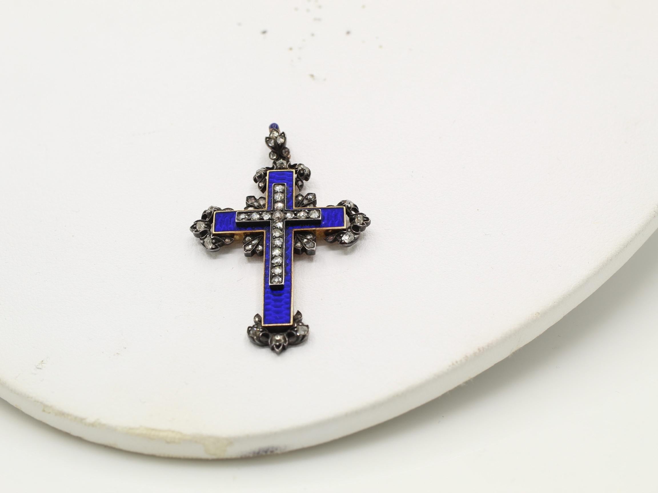 Rare antique early 19th century cross pendant. Beautifully designed and masterfully handcrafted in silver on gold. a smaller cross set with rose cut diamonds is set on a larger cross with gorgeous navy blue enamel. A true piece of art and wonderful