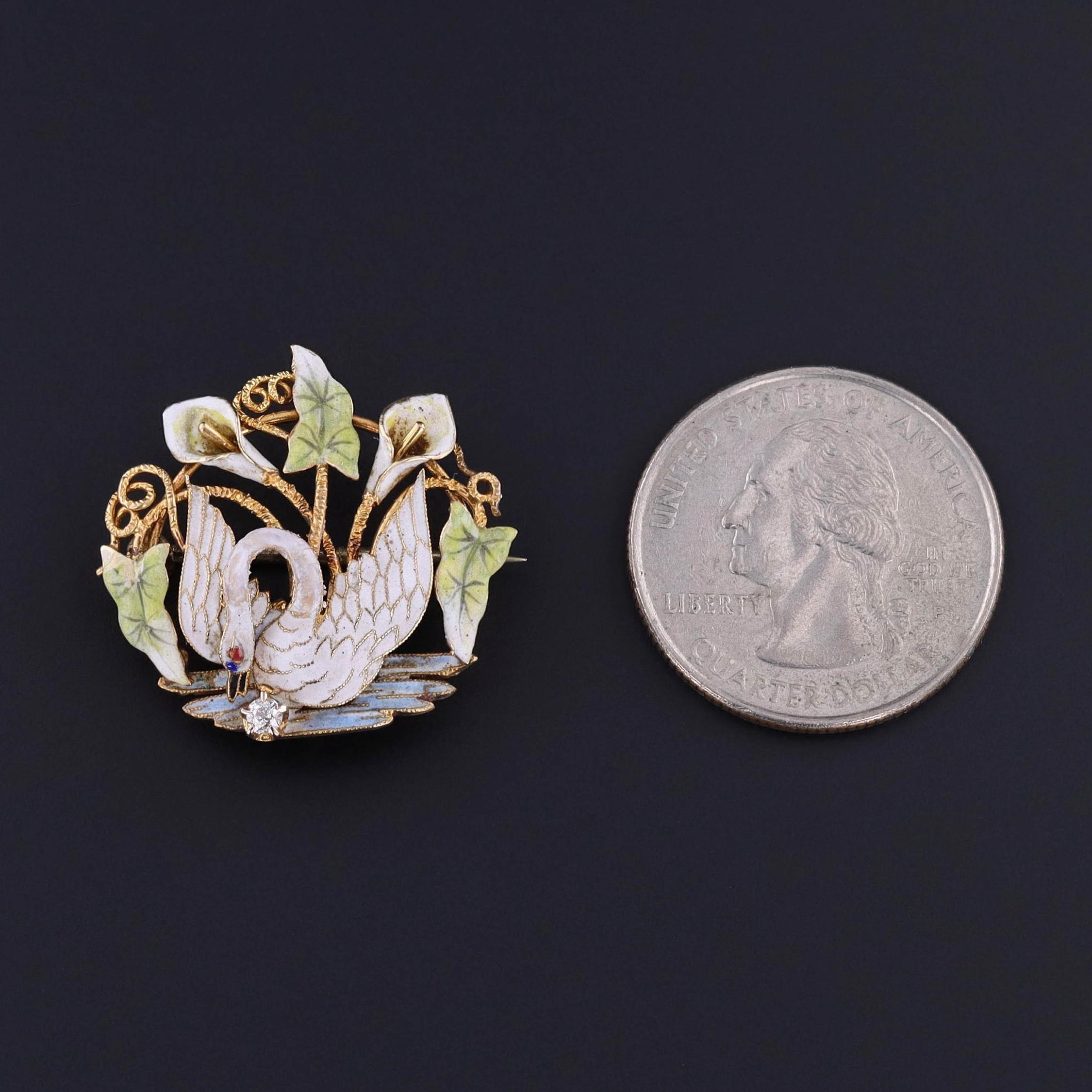 Antique Enamel Swan Brooch: This 14k gold and enamel brooch dates to the late Victorian era and features a swan nestled between two lilies and accented by a diamond.

This piece measures 1 inch from top to bottom by 1 inch wide and weighs 4.66