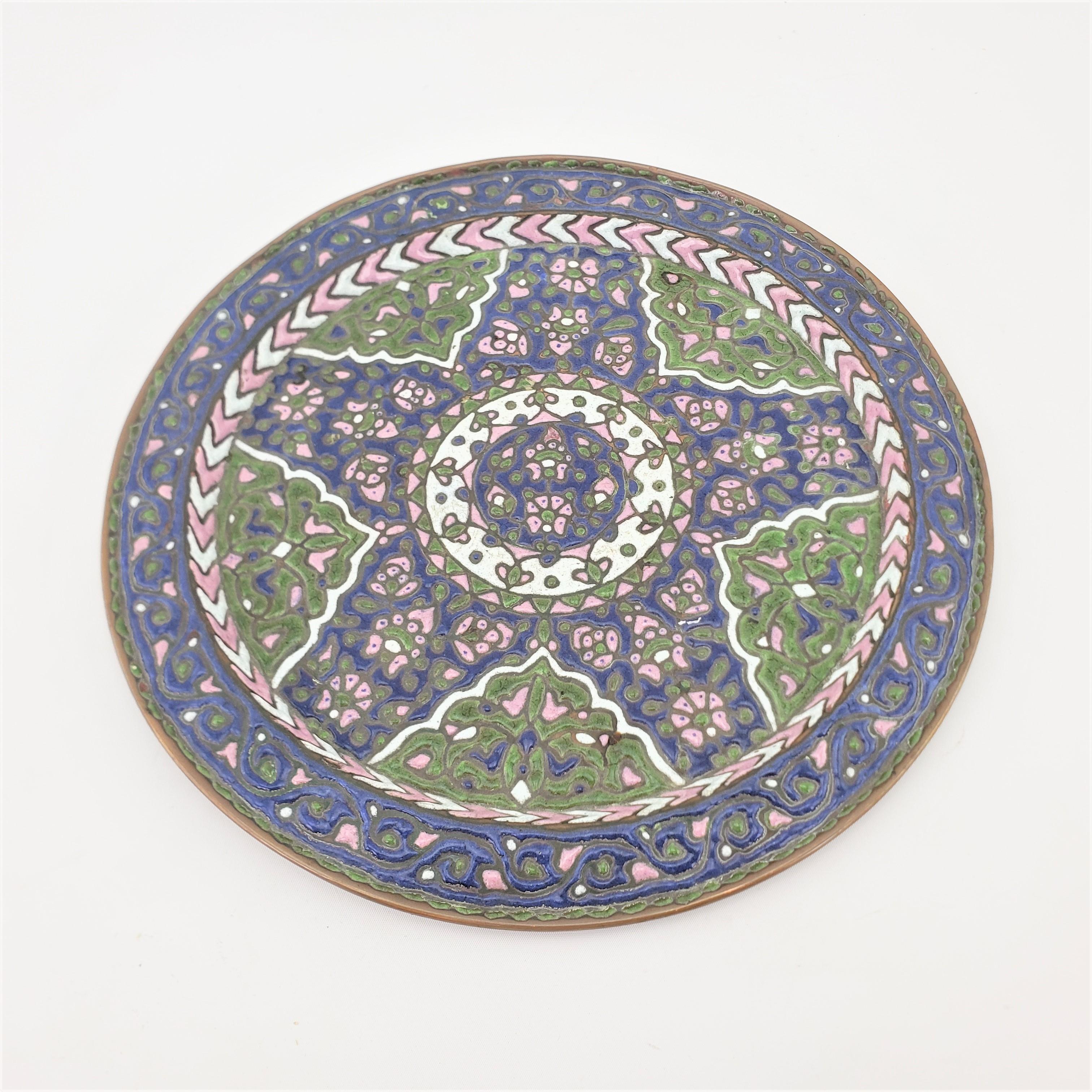 This elaborately decorated enameled brass charger or wall hanging is unsigned, but presumed to have originated from India and dating to approximately 1920 and done in an Anglo-Indian style. The plate is intricately hand-crafted with enamel