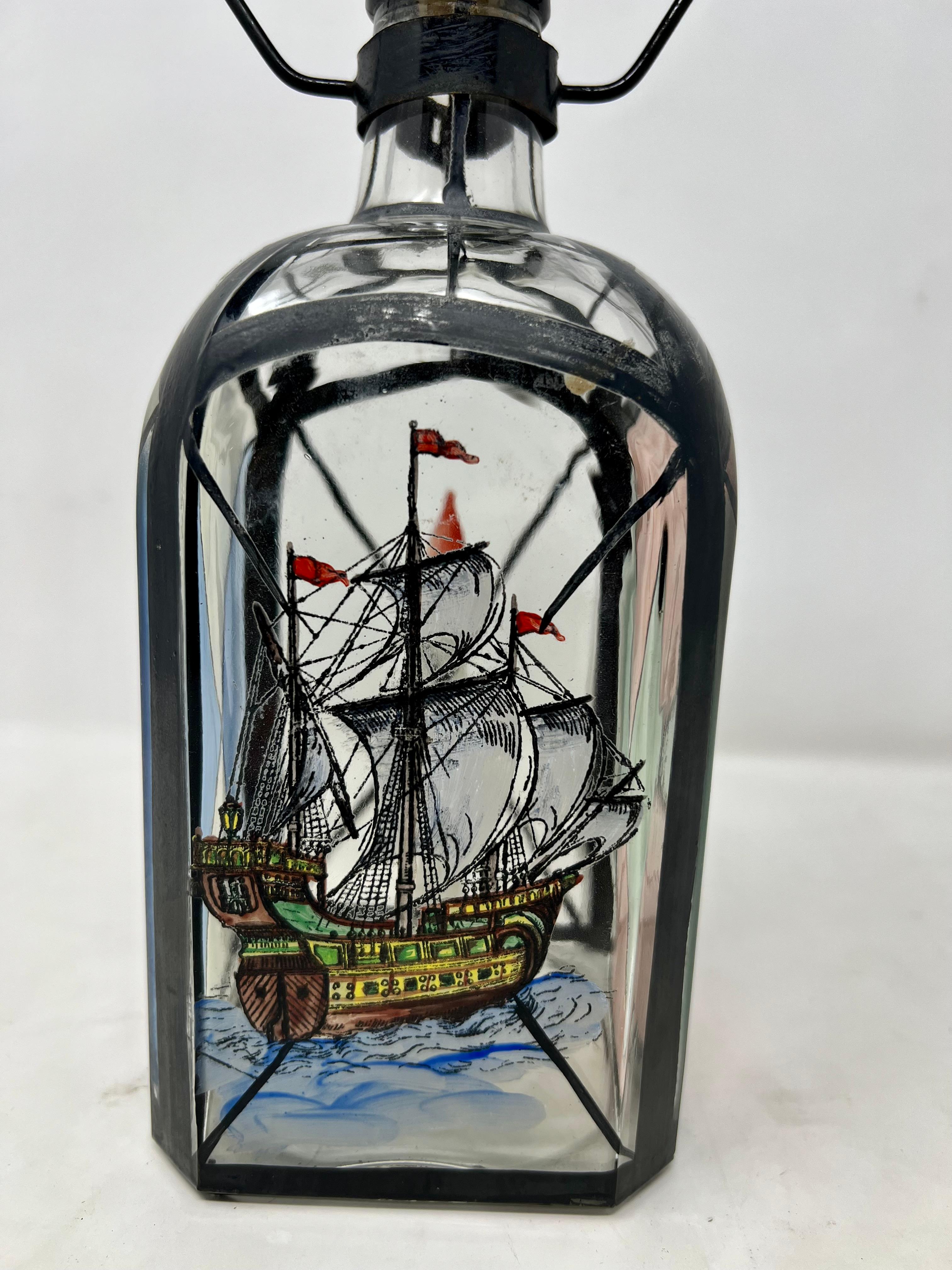 Antique decanter with enamled ship design.