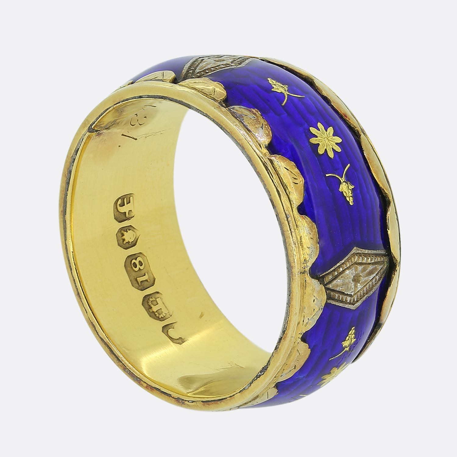 Here we have an antique enamelled band ring taken from the late Georgian period. Crafted from a rich 18ct yellow gold, this piece showcases a striking deep blue enamelled centre adorned with delicate gold floral motifs and ornate diamond shaped