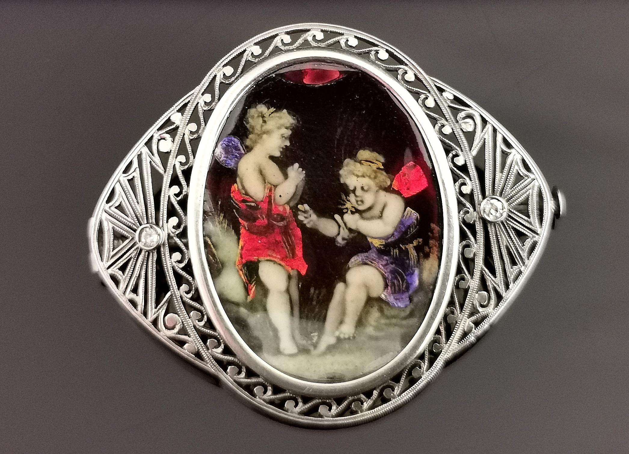 A beautiful antique, French Art Nouveau era enamelled fairy brooch.

This is such an unusual piece of antique jewellery, very unique in its design, the centre features an enamelled celluloid plaque depicting a pair of fairies in a garden, there are