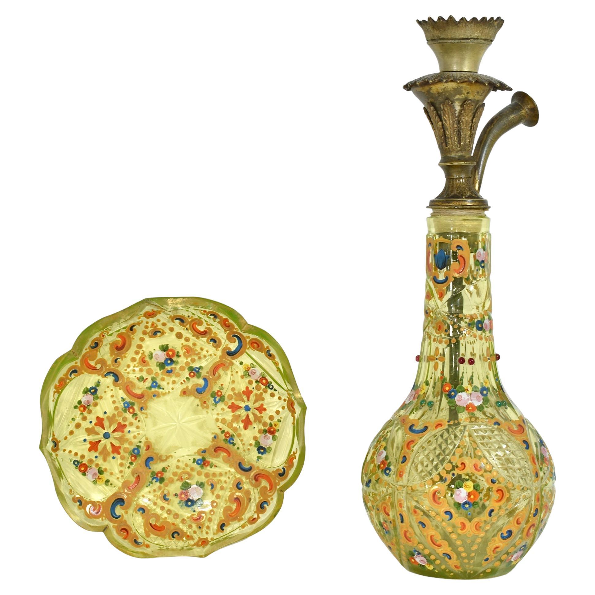 A Bohemian ouraline enameled and cut glass hookah base and matching plate
Early 19th century
Very rare Lime-Green color
Cut and enamelled with flowers and gilded scrolls, and decorated with ruby jewel beads
The plate with cut gilded rim
Made by