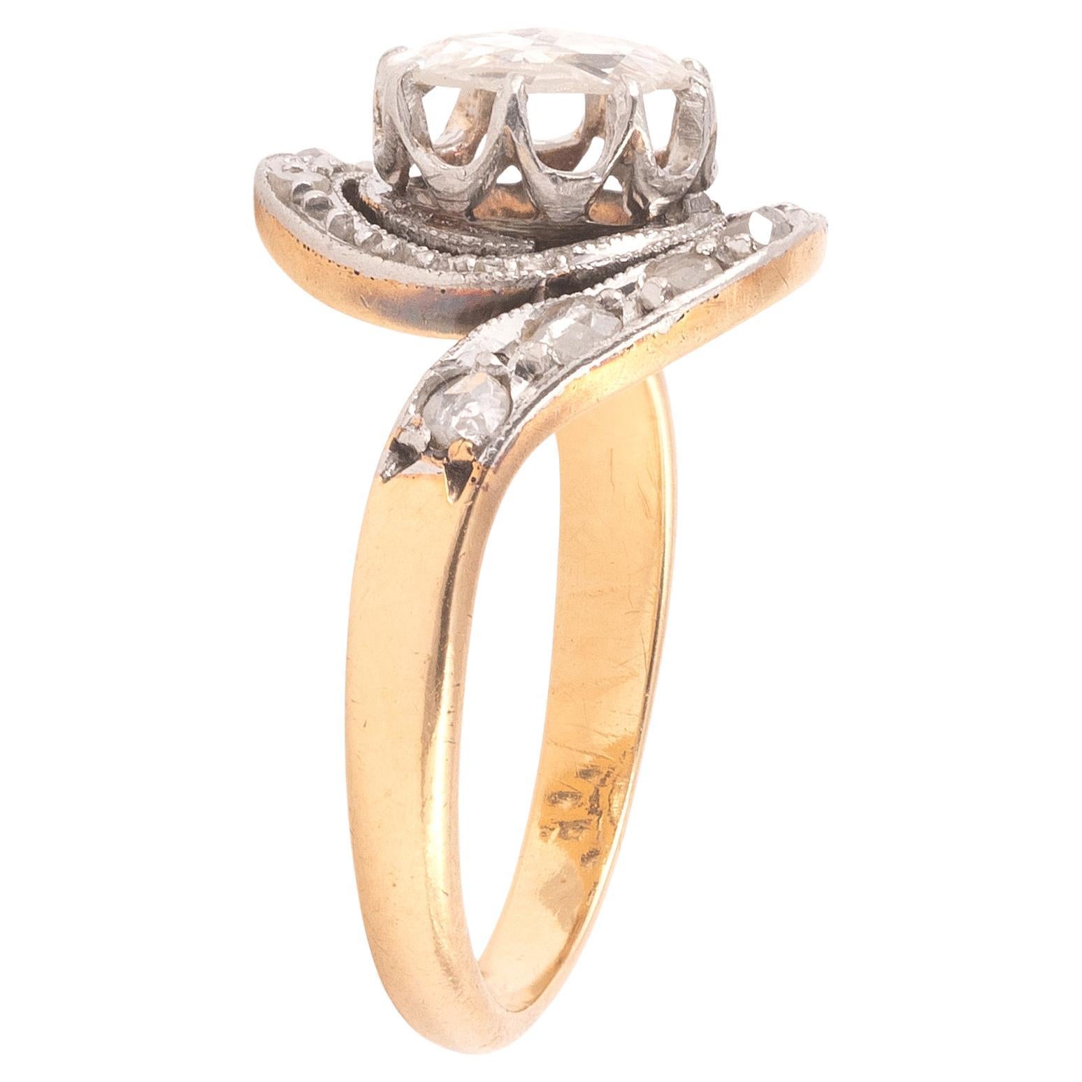 Antique 18K yellow gold and platinum Tourbillon ring set with lines of rose-cut diamonds and centered with an a rose-cut diamond approx. 1.2ct  
Size 7  
Weight: 3.86gr.

