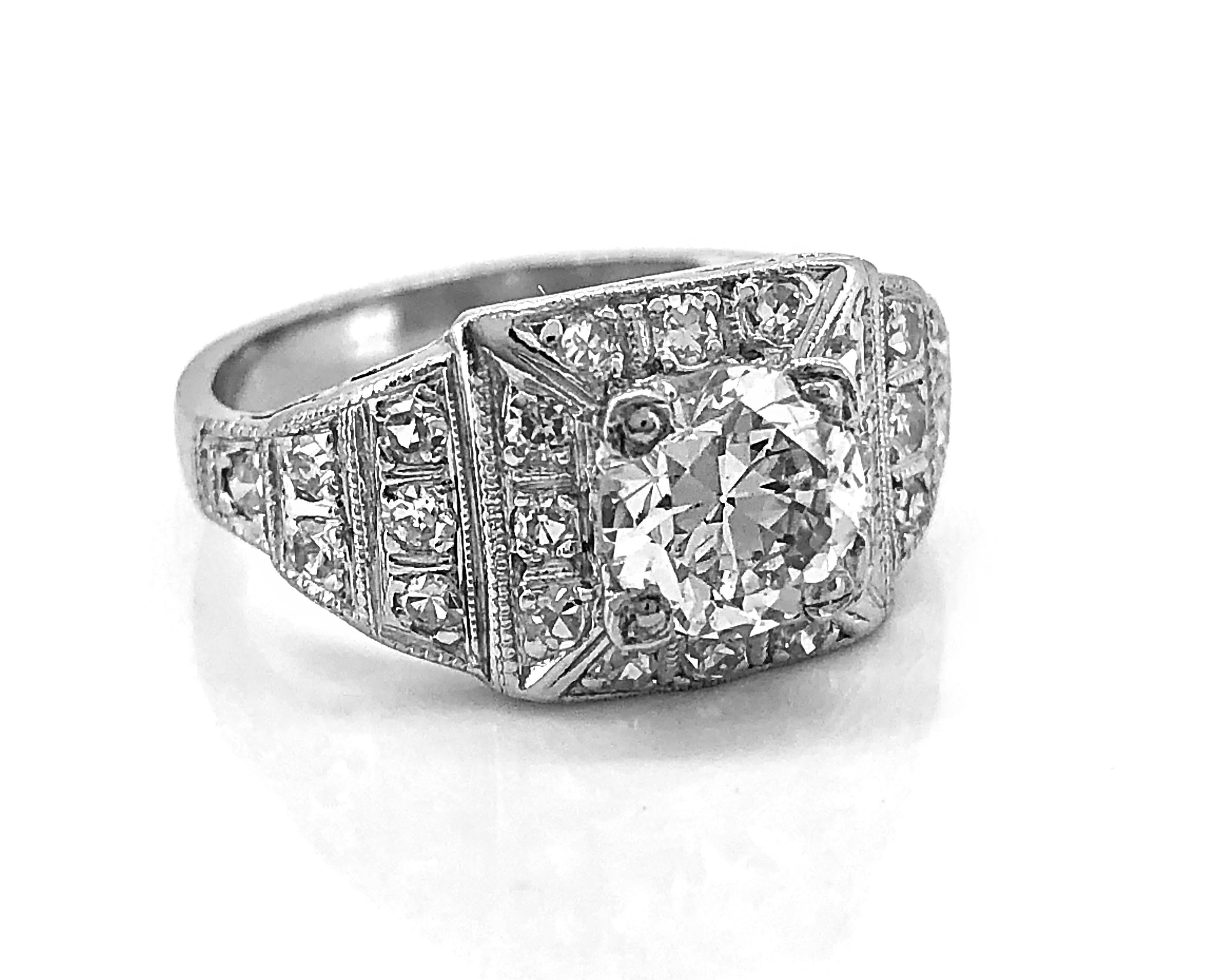A stunning platinum antique engagement ring featuring a .97ct. apx. European cut center diamond with SI3 clarity and H color. The center diamond is set with trefoil prongs and is surrounded with diamonds in a square style with a step down pattern on