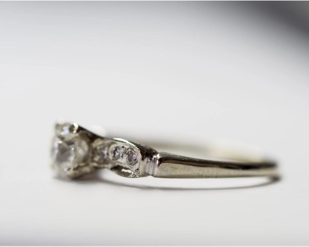 Item Description:
This is an amazing hand crafted ring! Featuring a center stone of .70ct with an amazing fire! The ring is approximately from 1930 and it features and OLD Miner cut diamond. The accompanying side stones are full cut round brilliants