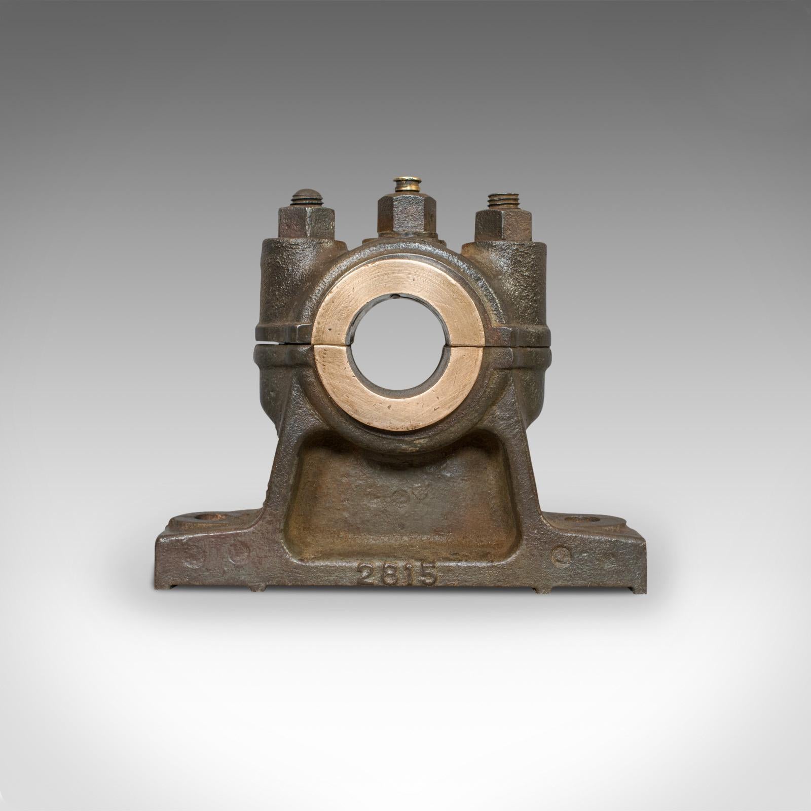 This is an antique engine bearing with polished finish. An English, cast iron and bronze desk ornament or paperweight, and dating to the Victorian period, circa 1900.

Fascinating mechanical form and interest
Displays a desirable aged