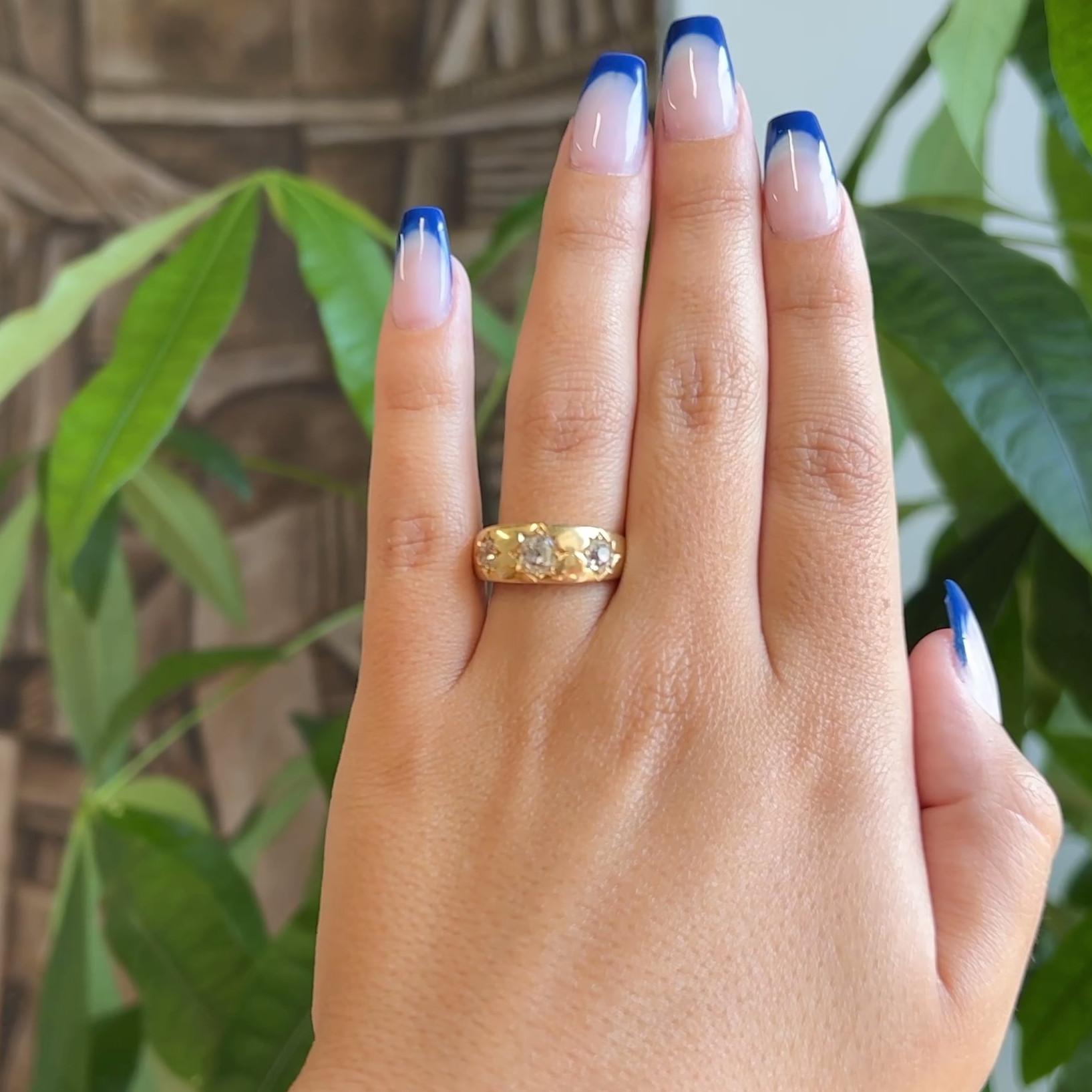 One Antique English 1.20 Carats Old Mine Cut Diamonds 18 Karat Yellow Gold Three Stone Ring. Featuring three old mine diamonds with a total weight of approximately 1.20 carats, graded I color VS clarity. Crafted in 18 karat yellow gold with English