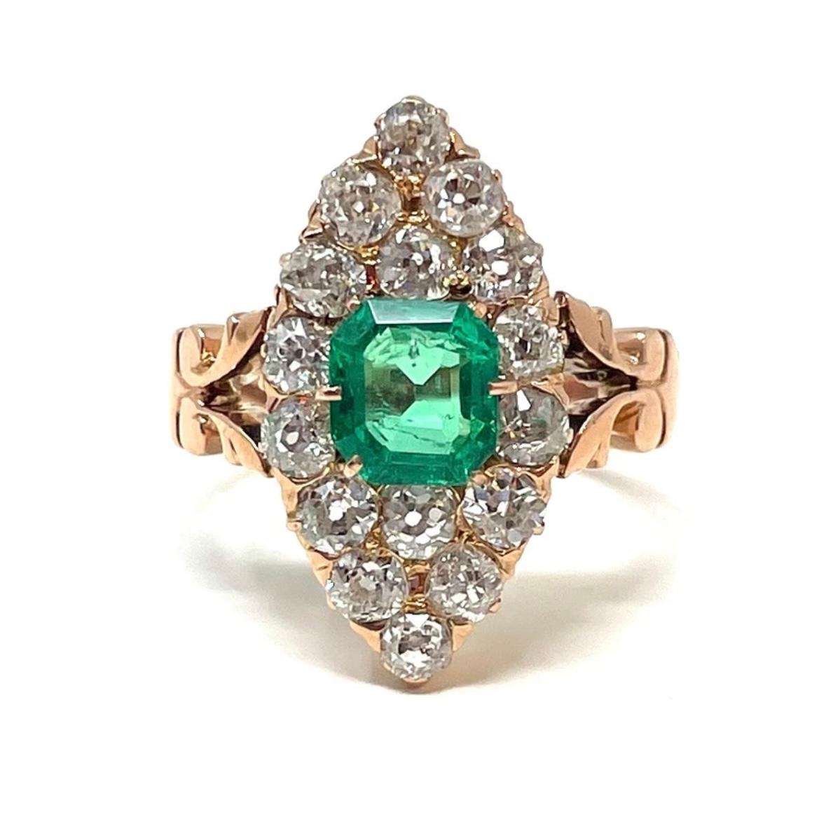 A wonderful emerald and diamond ring navette ring containing an approximately 1.25 carat emerald and old mine cut diamonds weighing approximately 2.24 carats total weight set in 15 carat gold. 