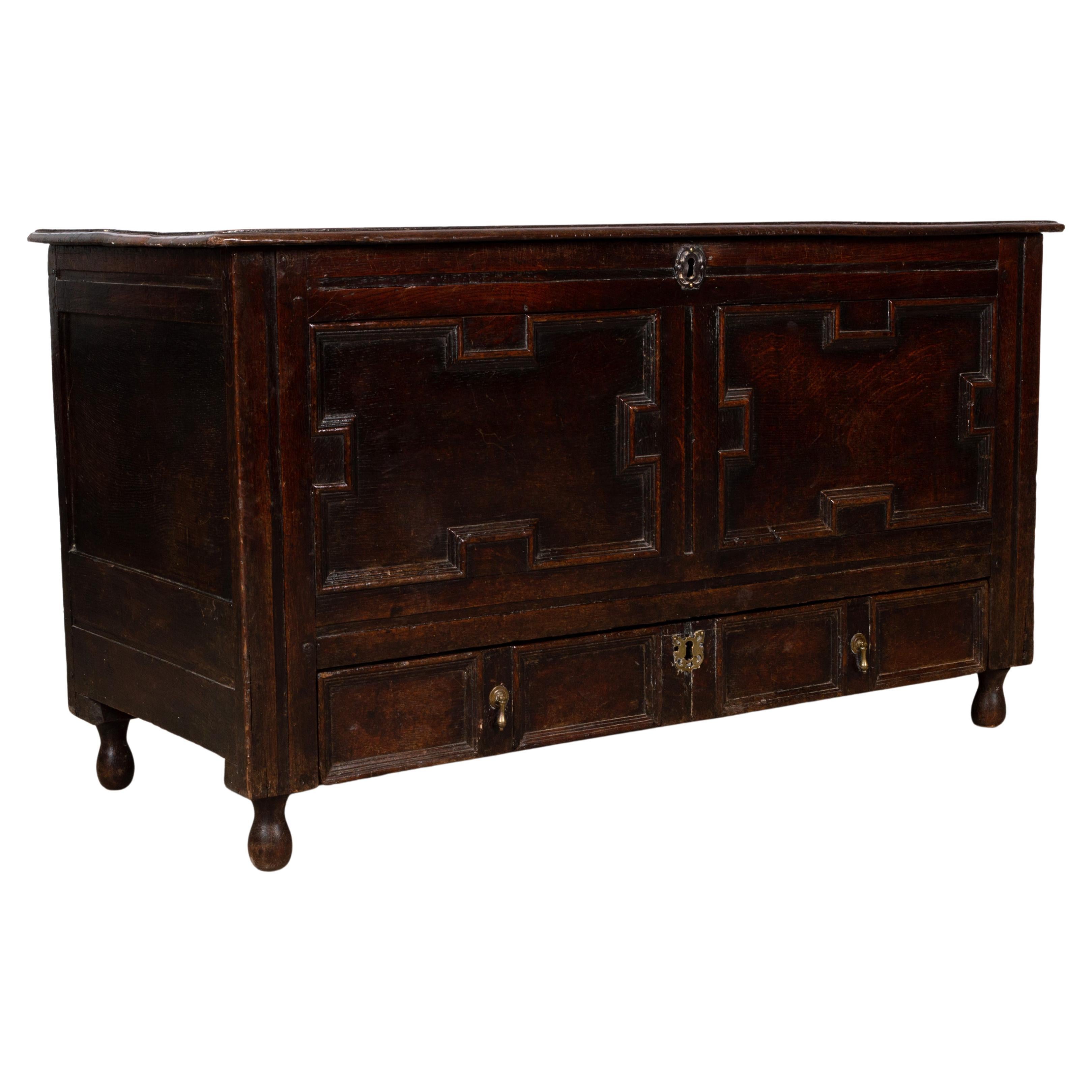 A Jacobean oak mule chest

Antique English 17th century Jacobean Oak Mule Chest circa 1660

A Charles II Jacobean oak mule chest
17th century, geometric moulded panel front, long drawer to base, on stile legs and later turned feet.

An