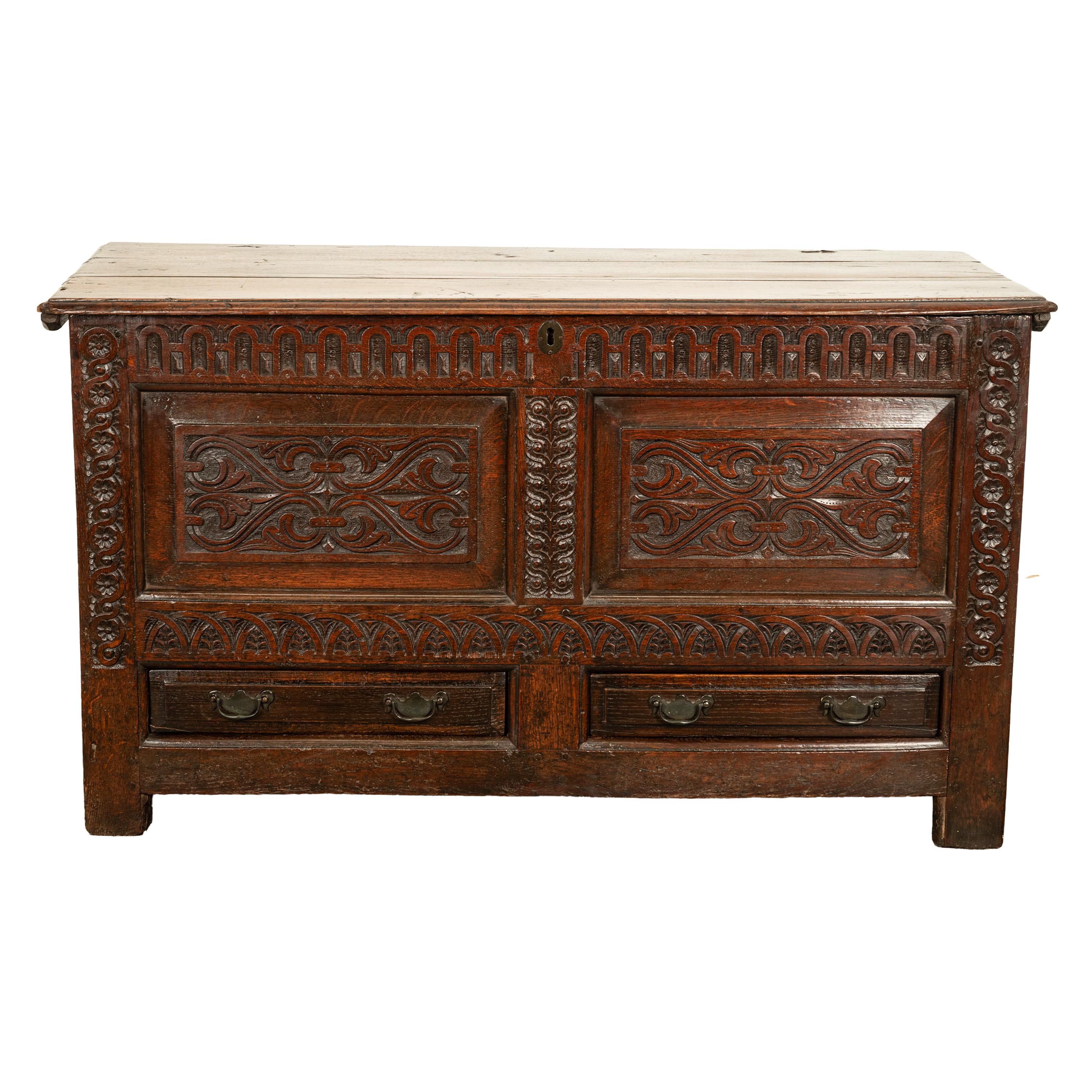 A wonderful Charles II carved oak coffer /mule chest, circa 1680.
The chest of fabulous colour & good original condition, the chest having a hinged lid with the original iron 'snipe' hinges. The carved front decorated with original period carving