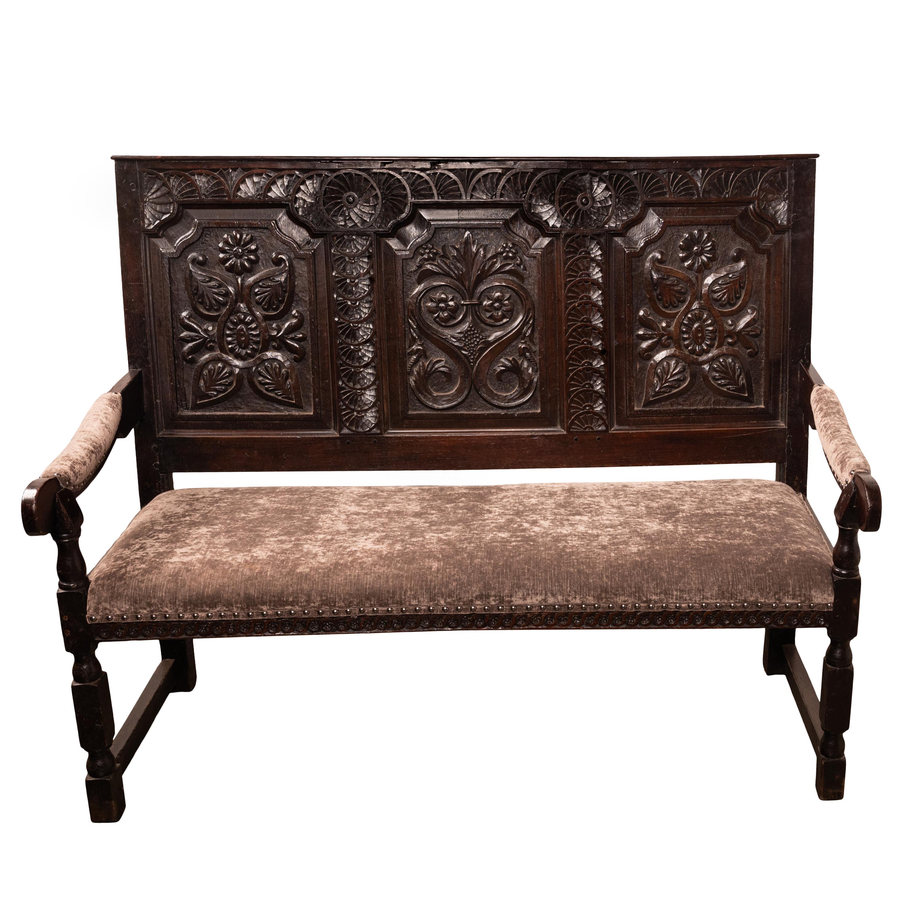 A very fine antique King Charles II, English Restoraion Period carved oak settle, England, Circa 1680.
This settle is from the period of the Restoration of the English monarchy under the House of Stuart monarchy, after the English Civil War. The