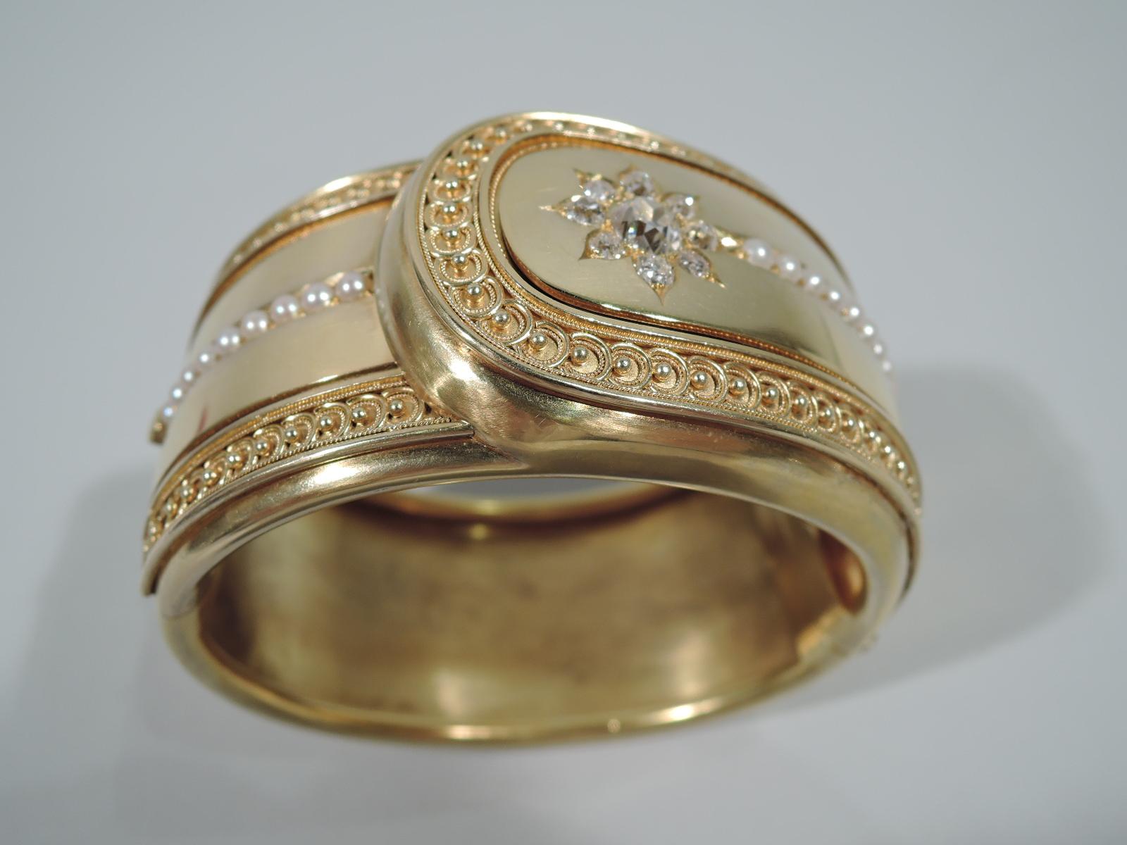 Victorian 18k gold cuff bracelet with applied rope and bead border and encrusted miner diamond starburst and seed pearls. England, ca 1880. 

Dimensions: Circumference 9 in x W 1 1/2 in. Heavy weight: 65 dwt.