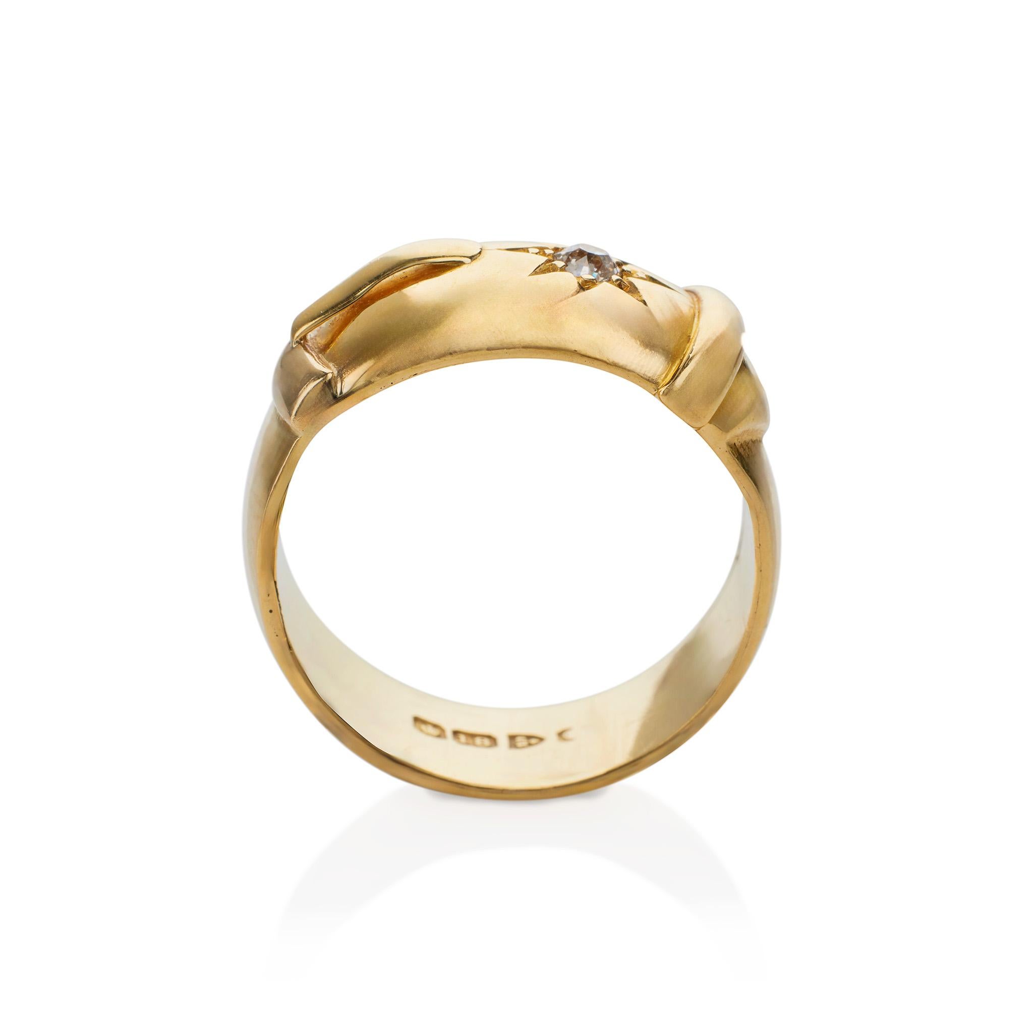 Made in Chester, this 18K gold English strap and buckle ring is set with an old mine-cut diamond. The ring centers a buckle motif highlighted by a star-set old mine-cut diamond accenting the strap. Charming and modern in its straightforward