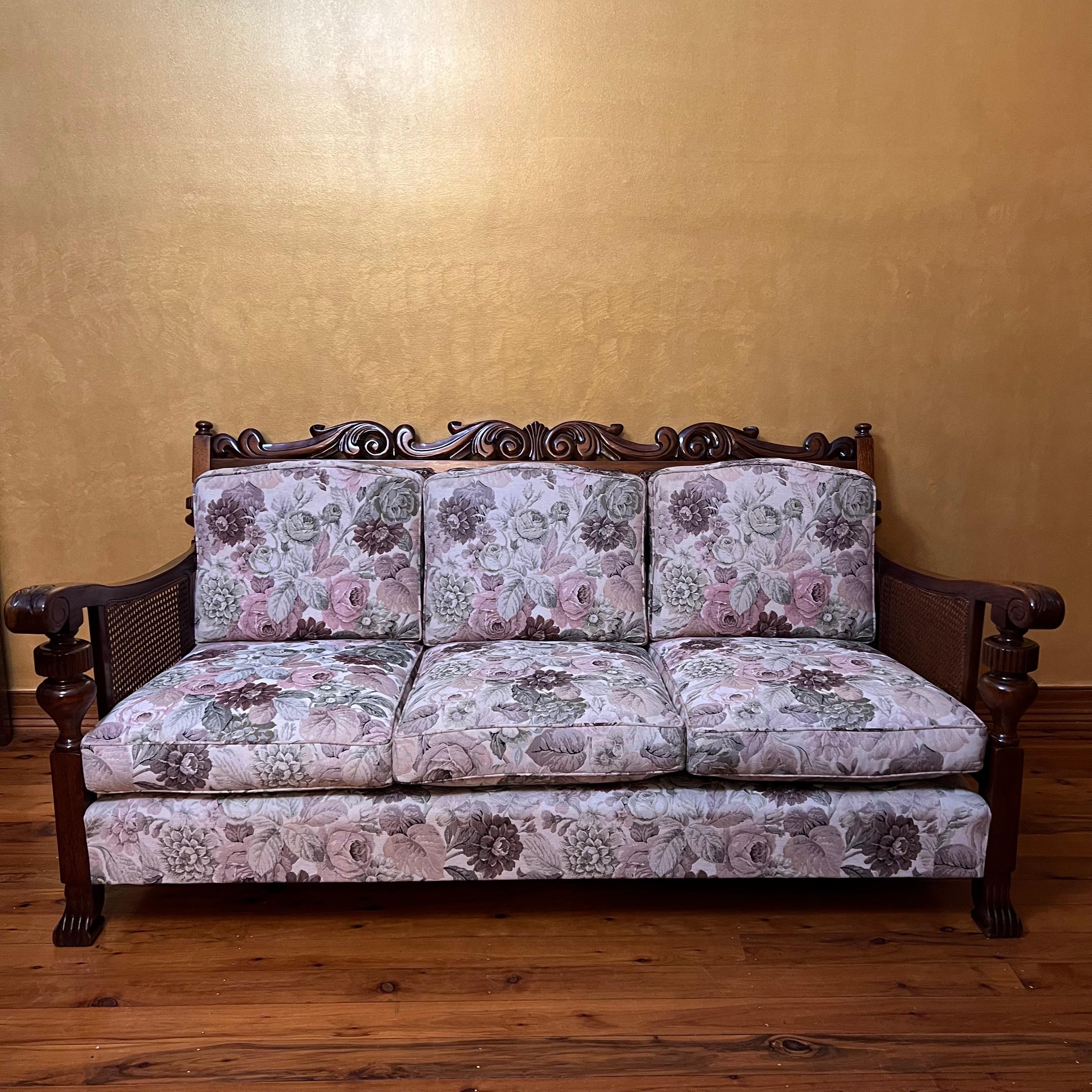 Carved detail on tops, arms and legs, cane detail on sides and back all in good condition, floral print fabric pillows are still original horse hair filling.

circa: 1920s

Measurements

Lounge: 81cm high, 168cm length, 84cm width 

Single