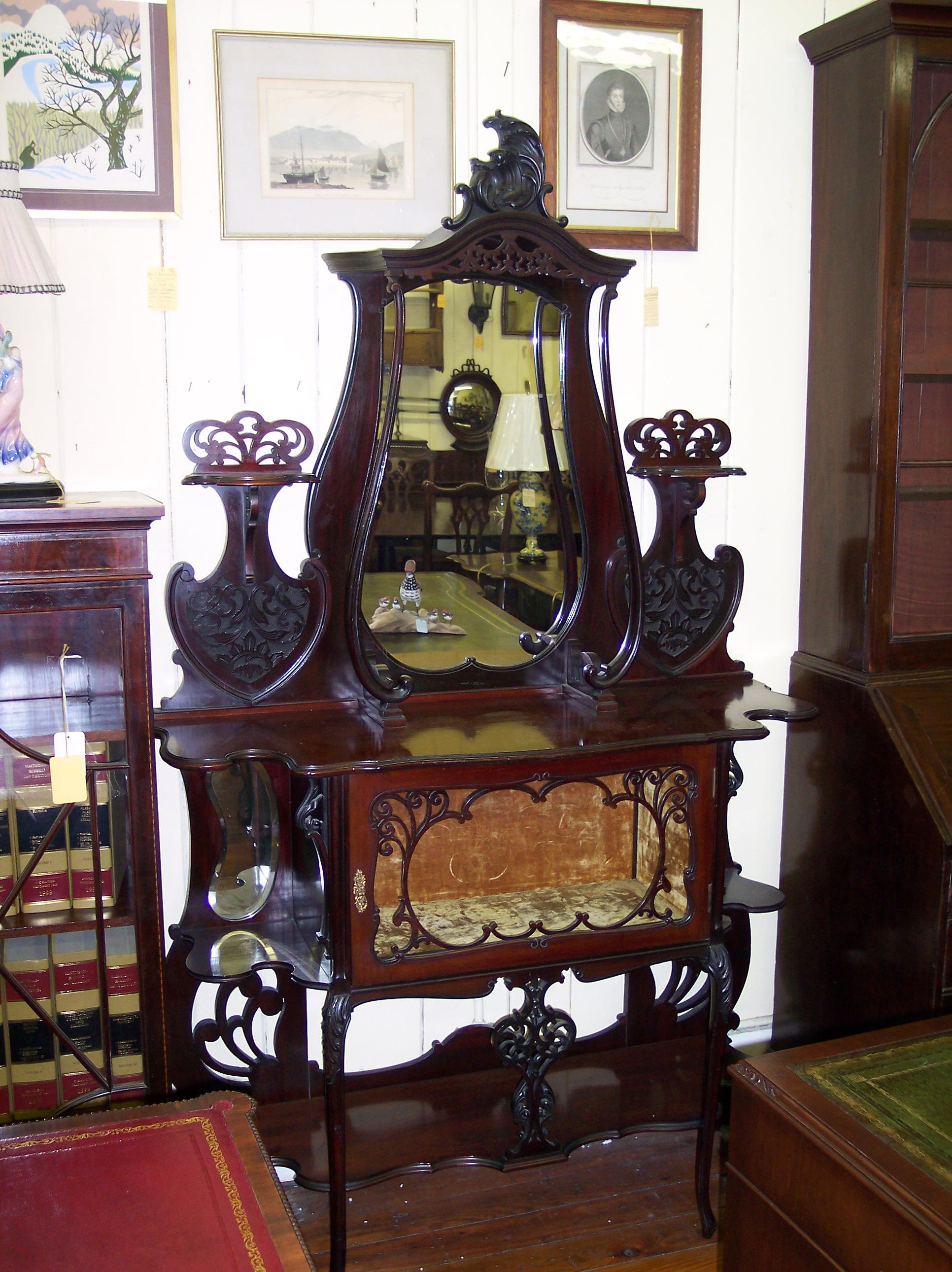 Superbly and intricately hand carved solid mahogany whatnot or display piece with an attached velvet-lined vitrine or specimen cupboard. Handsome fretted and pierced shelves for display. Great condition.
(Decorative pieces shown are not included).