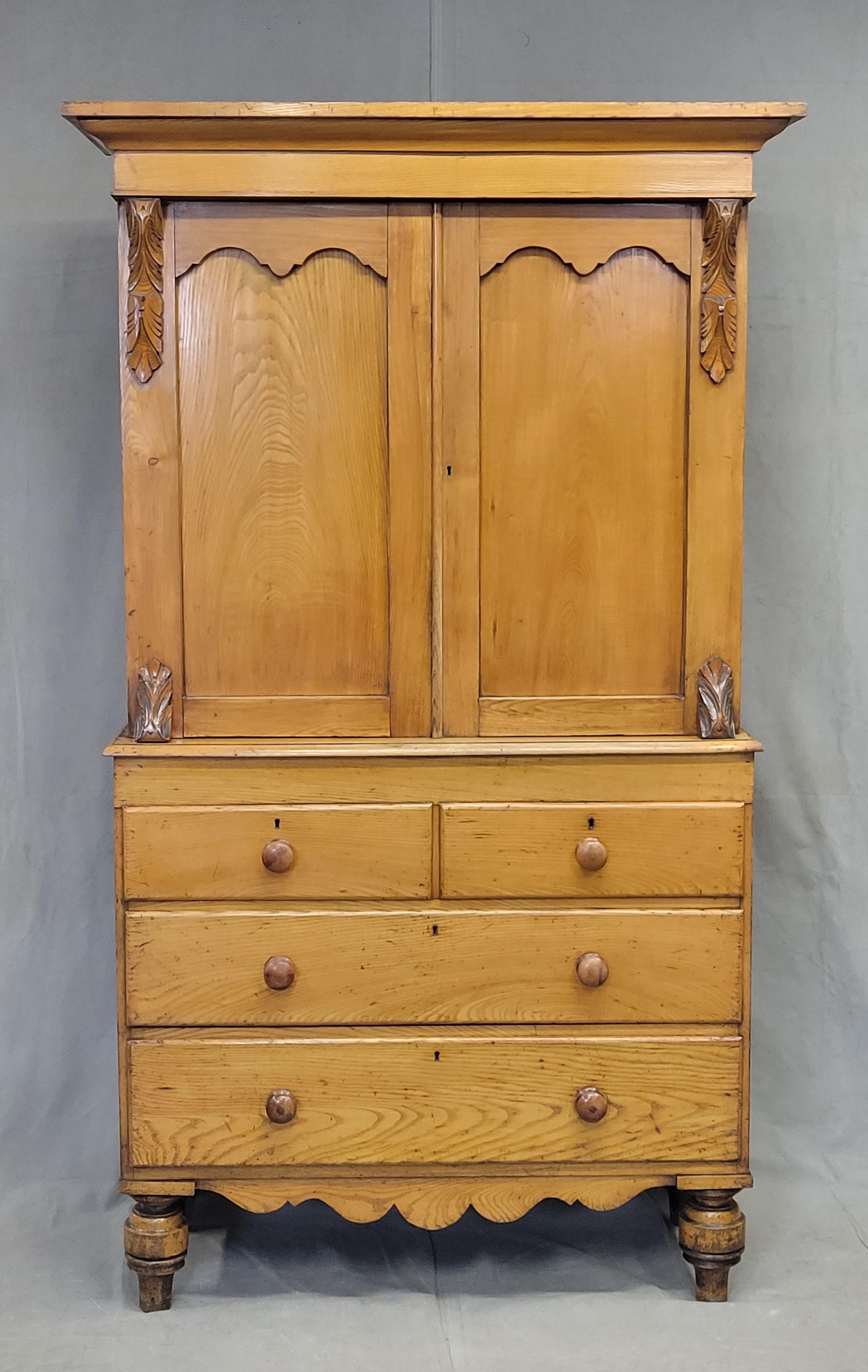 Antique 19th Century golden pine and elm linen press from Northern England or perhaps Scotland. The wood on this piece has a golden glowing patina and is expertly crafted out of elm panels on the front and pine on the side. Carved wood corbels on