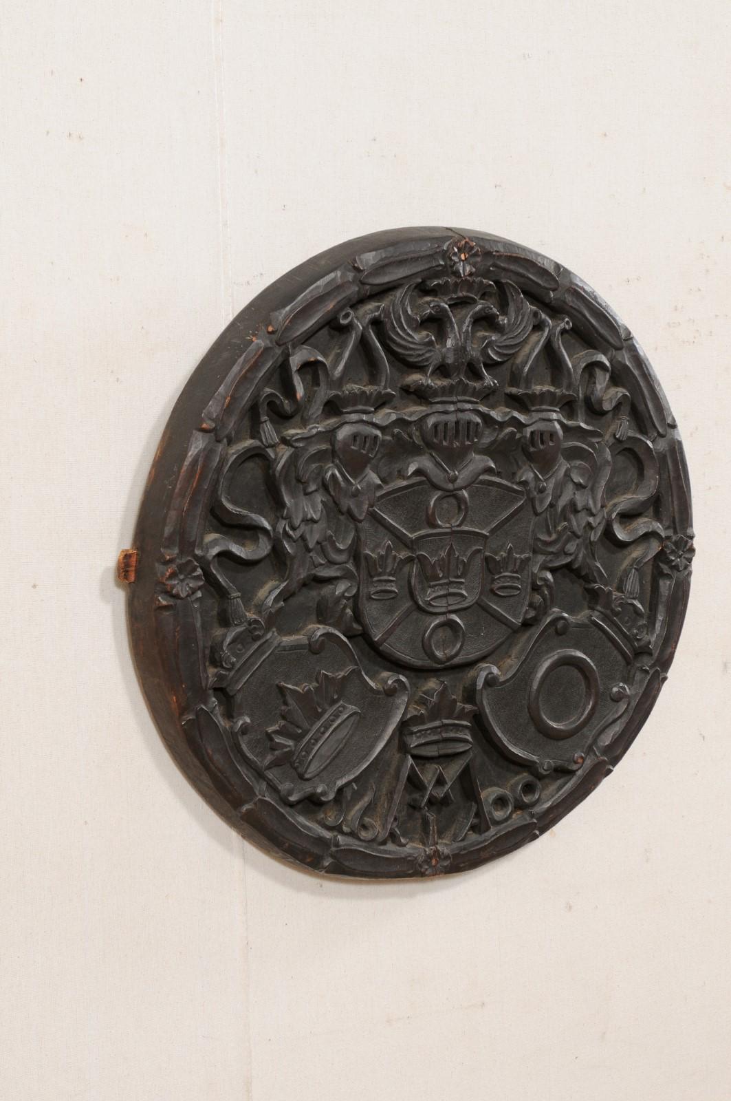 Wood Antique English Round Wall Plaque Carved in Knights, Shield & Crown Motif  For Sale