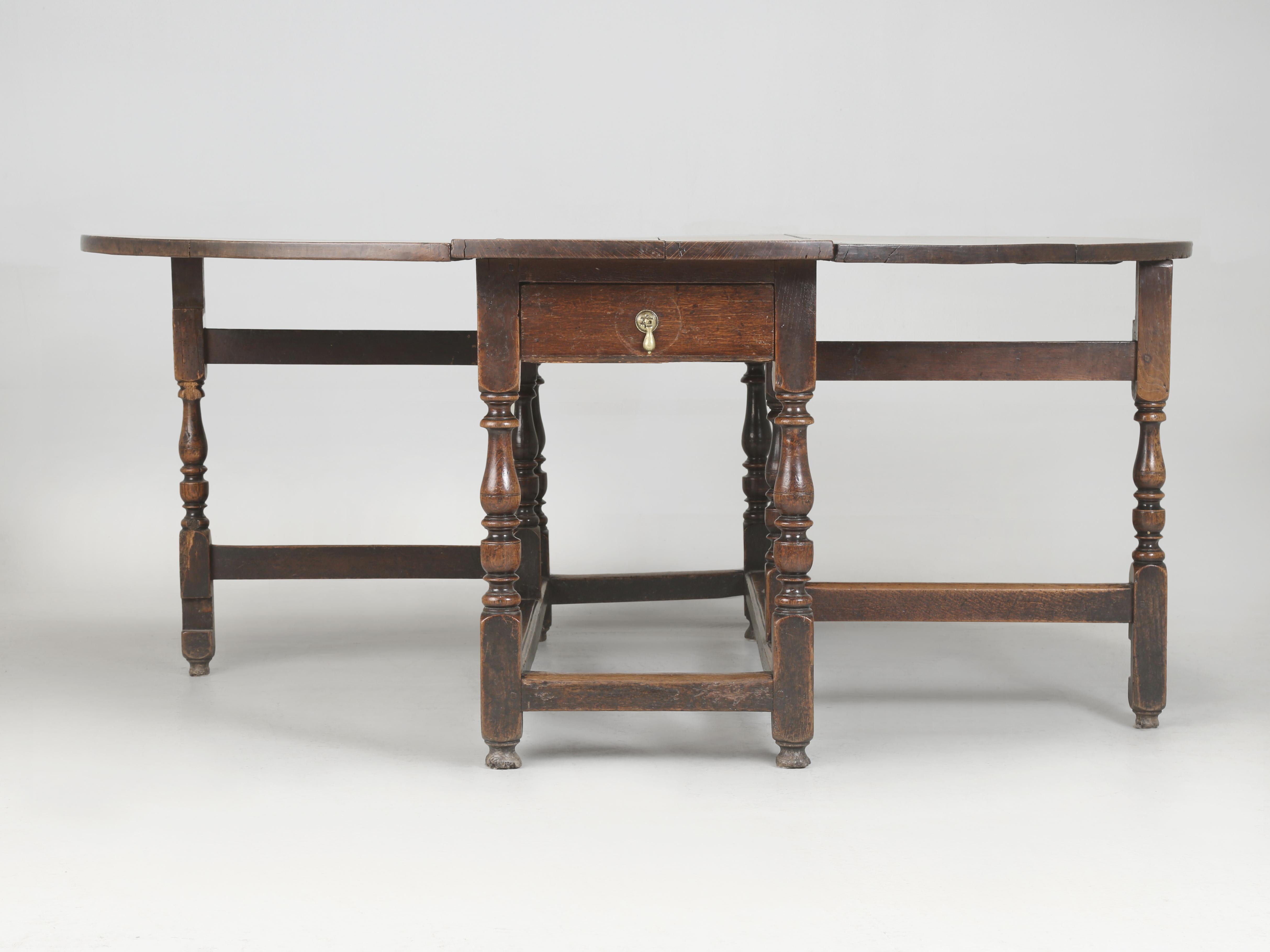 For us to find an Antique English Drop-Leaf Dining Table this old and in this unrestored condition is so unusual that we almost get a little giddy. The 250-year old patina, to what looks to be the original finish is almost unbelievable, now only if