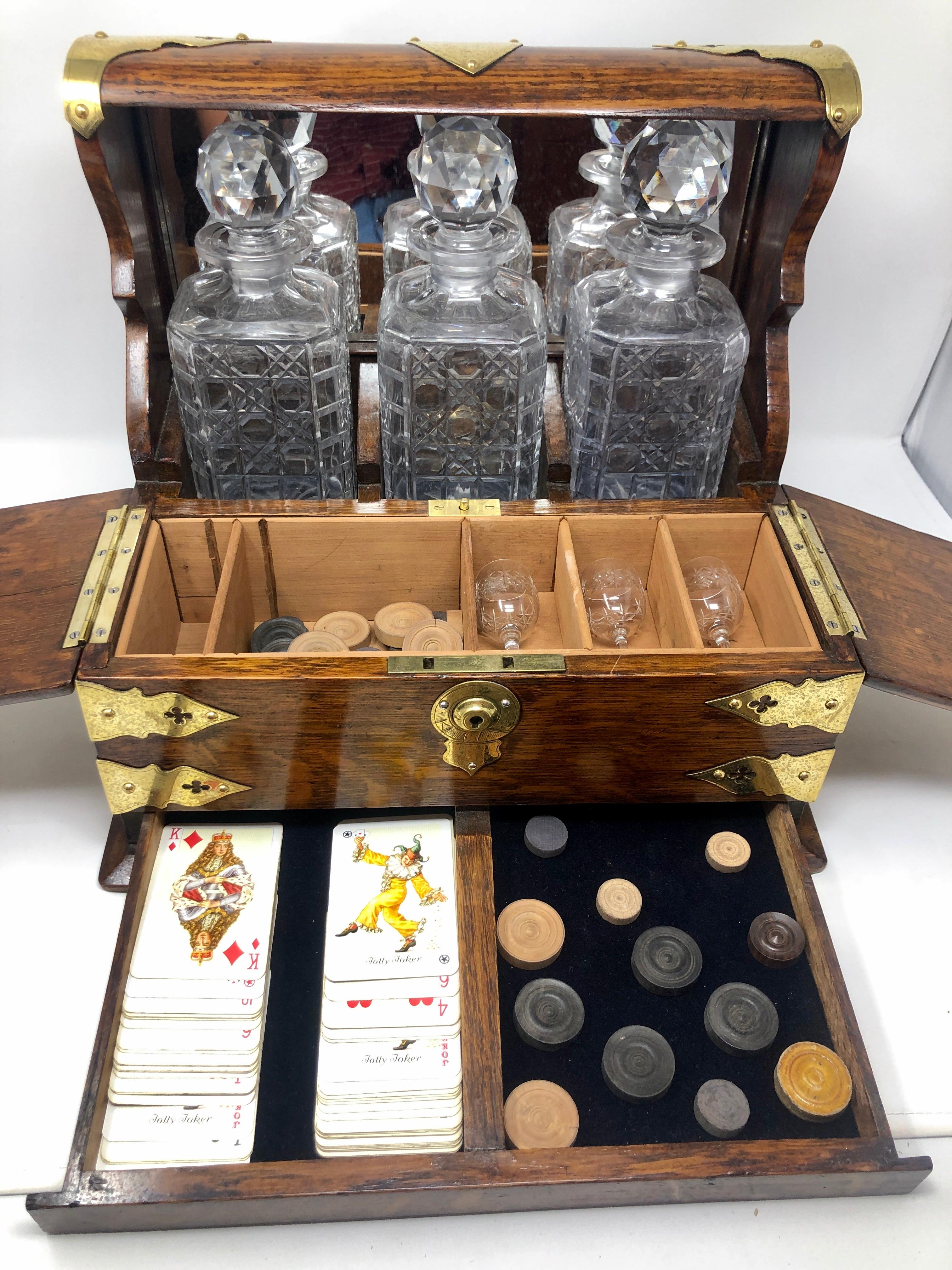 Antique English 3 bottle tantalus, games box & smoker's compendium, Circa 1890s.