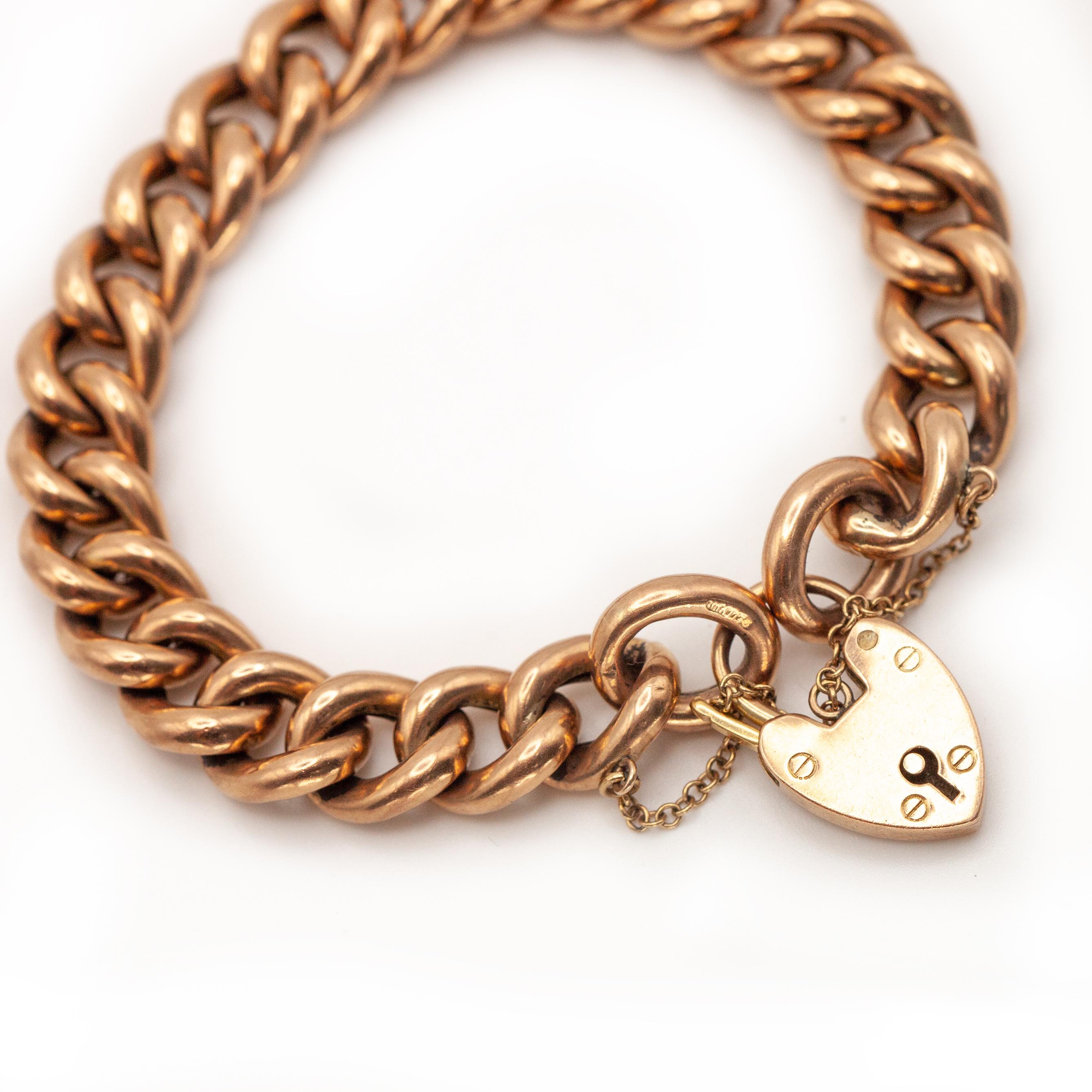 Victorian English antique bracelet crafted in solid 9K rose gold, this bracelet features classic curb links and fastens with a traditional heart-shaped padlock clasp, complete with its original safety chain for security.
The padlock clasp—a romantic