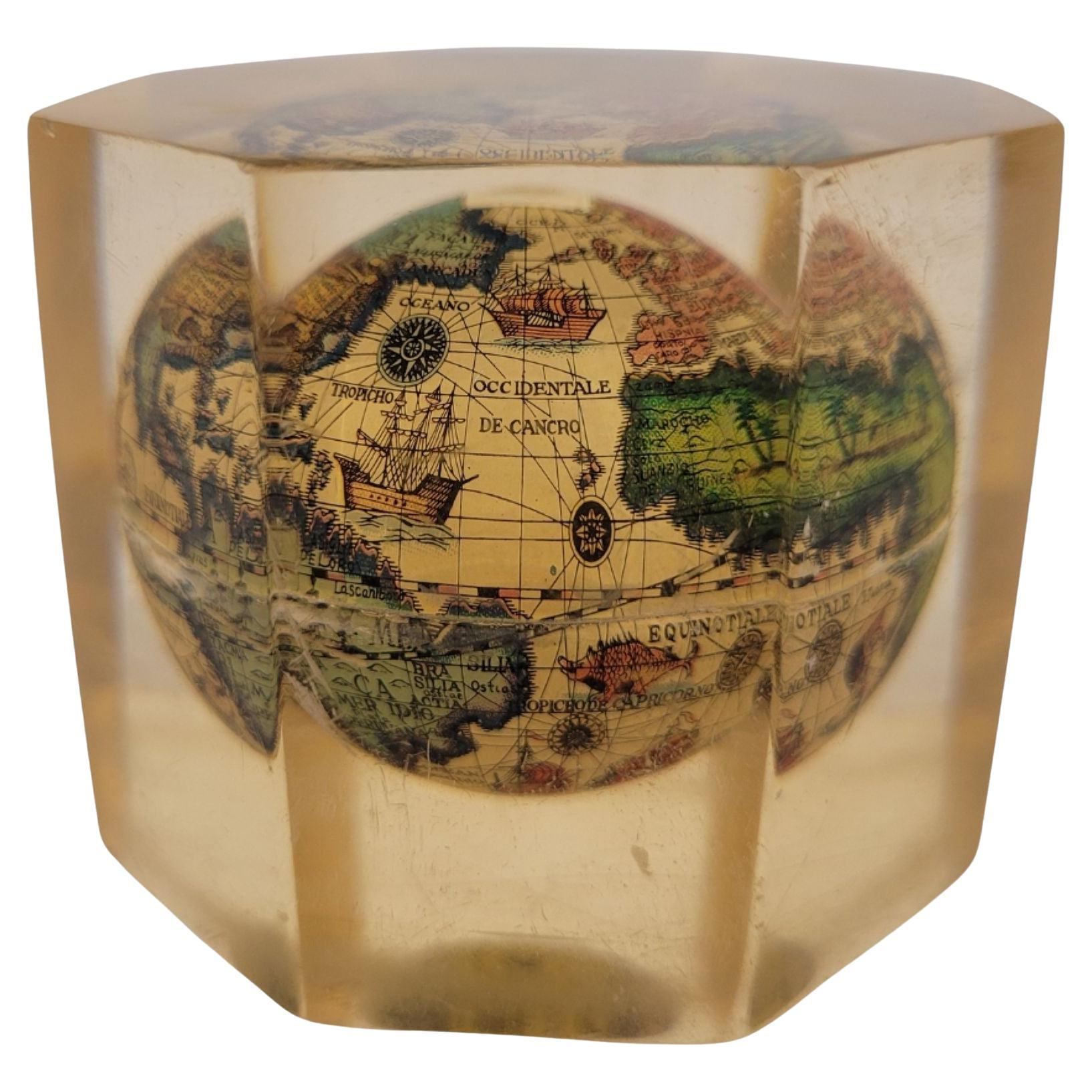Antique English acrylic paperweight with a globe inside