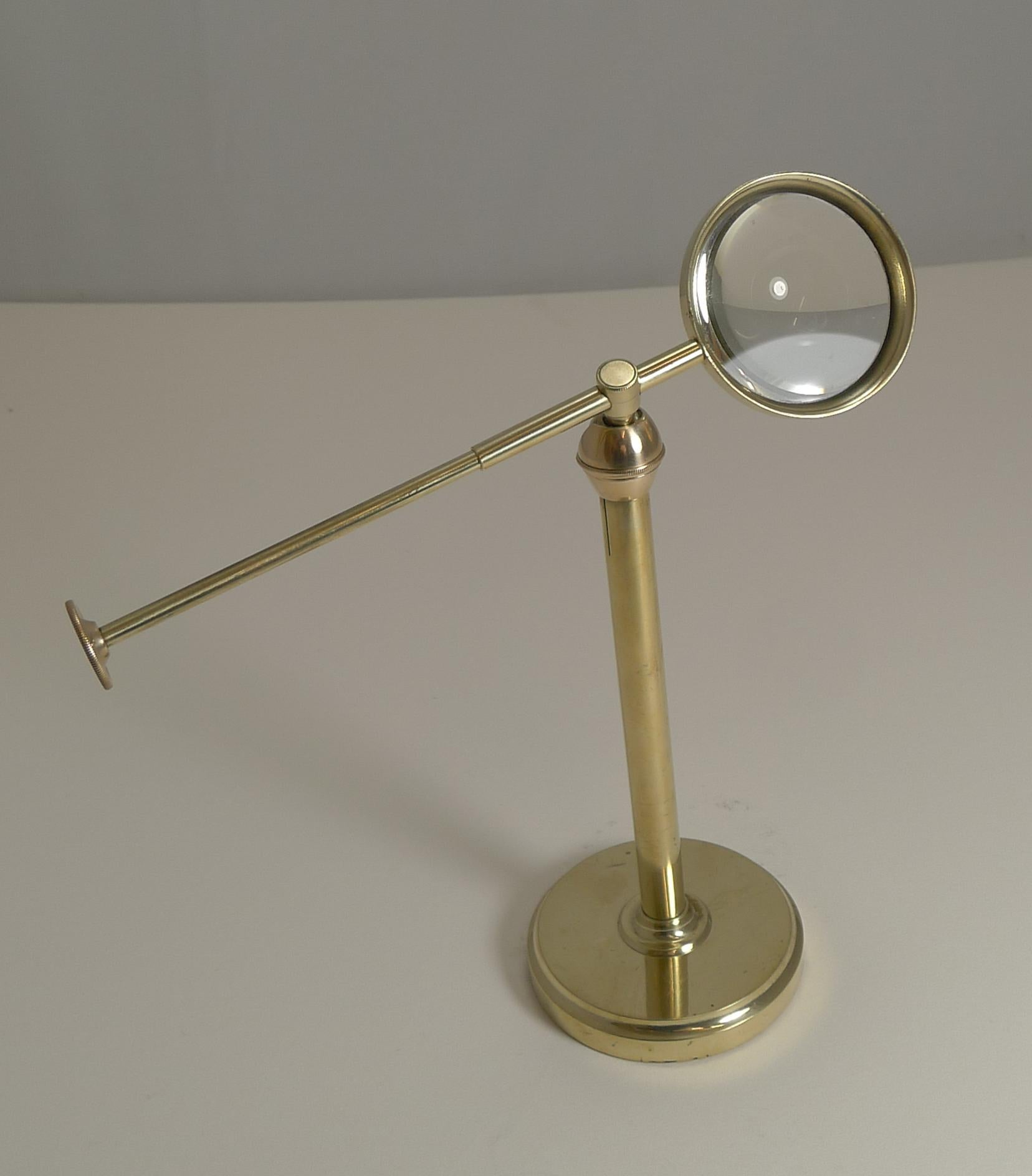 antique brass magnifying glass on stand