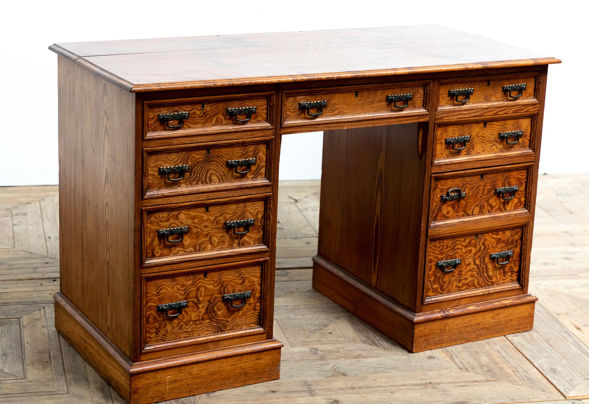 A striking 19th century pine twin pedestal desk. Constructed of Oregon Pine (Douglas Fir) the wood has a wonderful rich warm glow and striking grain. The desk is of traditional form, a two plank top that stands on two pedestals lined with graduated