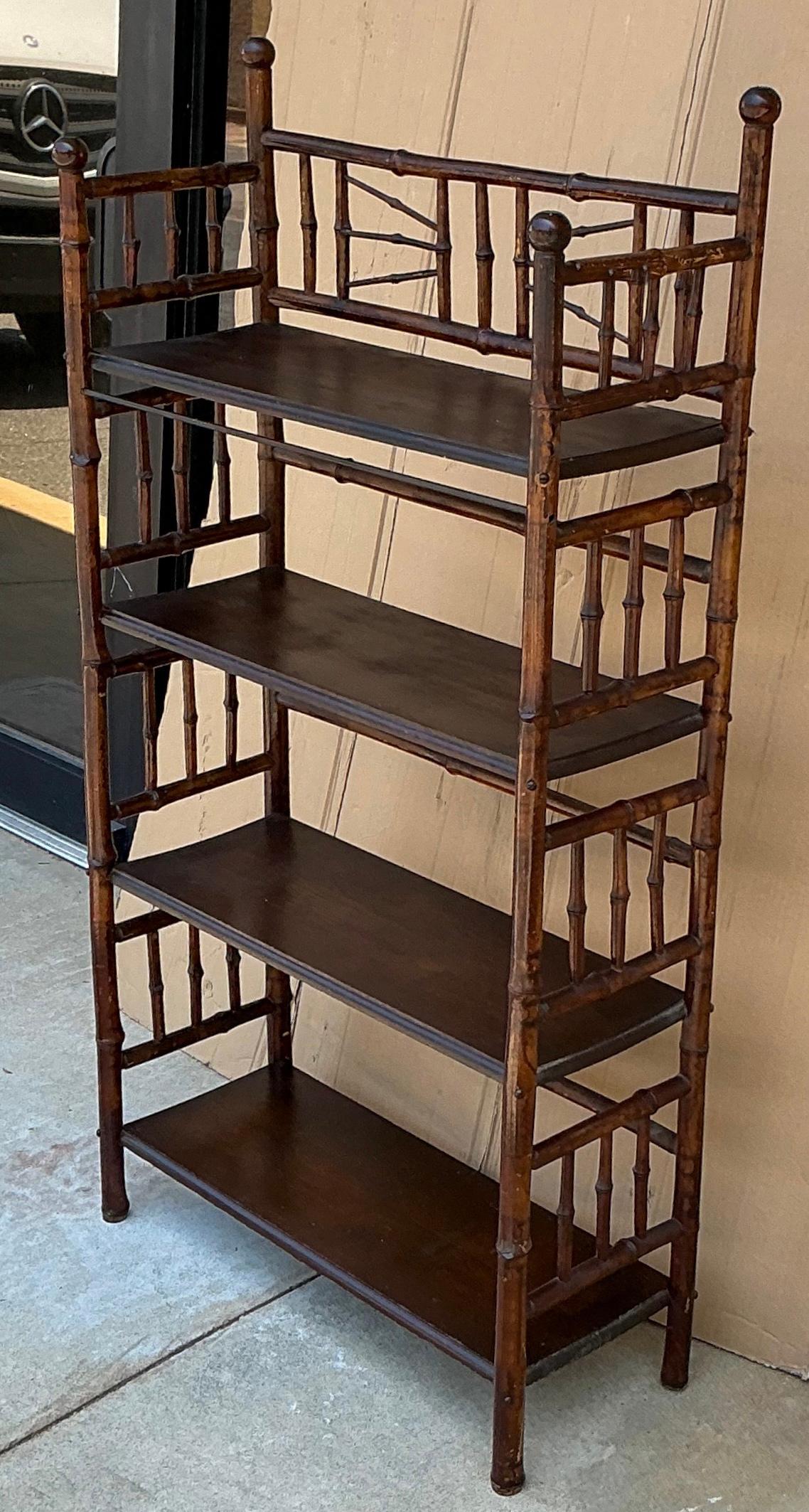This is a nice early burnt bamboo bookshelf. It has almost stick and ball styling. It does show age wear but is structurally sound. It is English and has Aesthetic Movement styling. 

My shipping is running two to five weeks. For islands like
