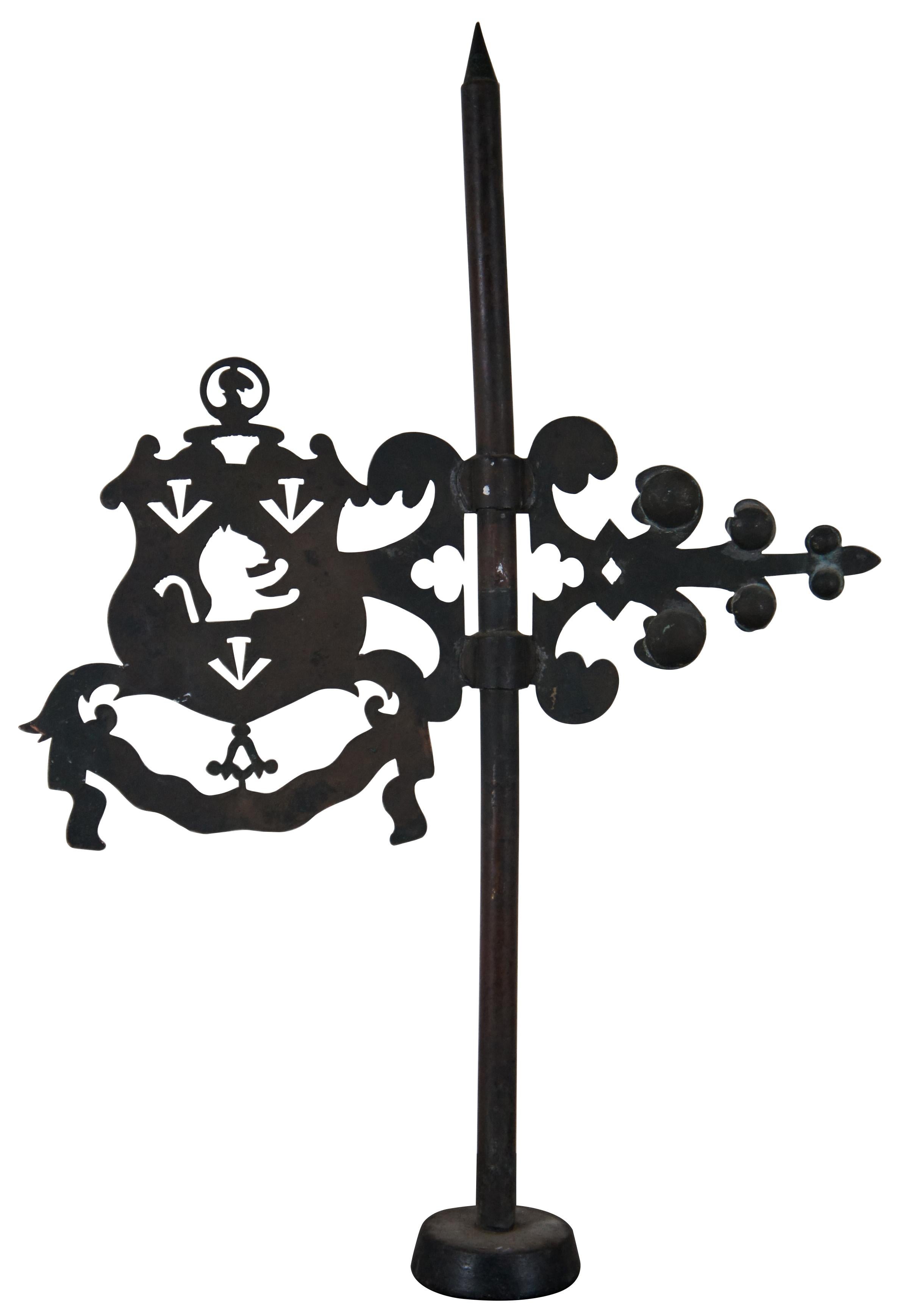An exceptional and rare 15th Century English wrought iron banneret weathervane with lightning rod. Features an ornate arrow and pierced coat of arms or crest with lion. Marked “4 lb” on base.

The Rampant Lion with the crown above its head stood